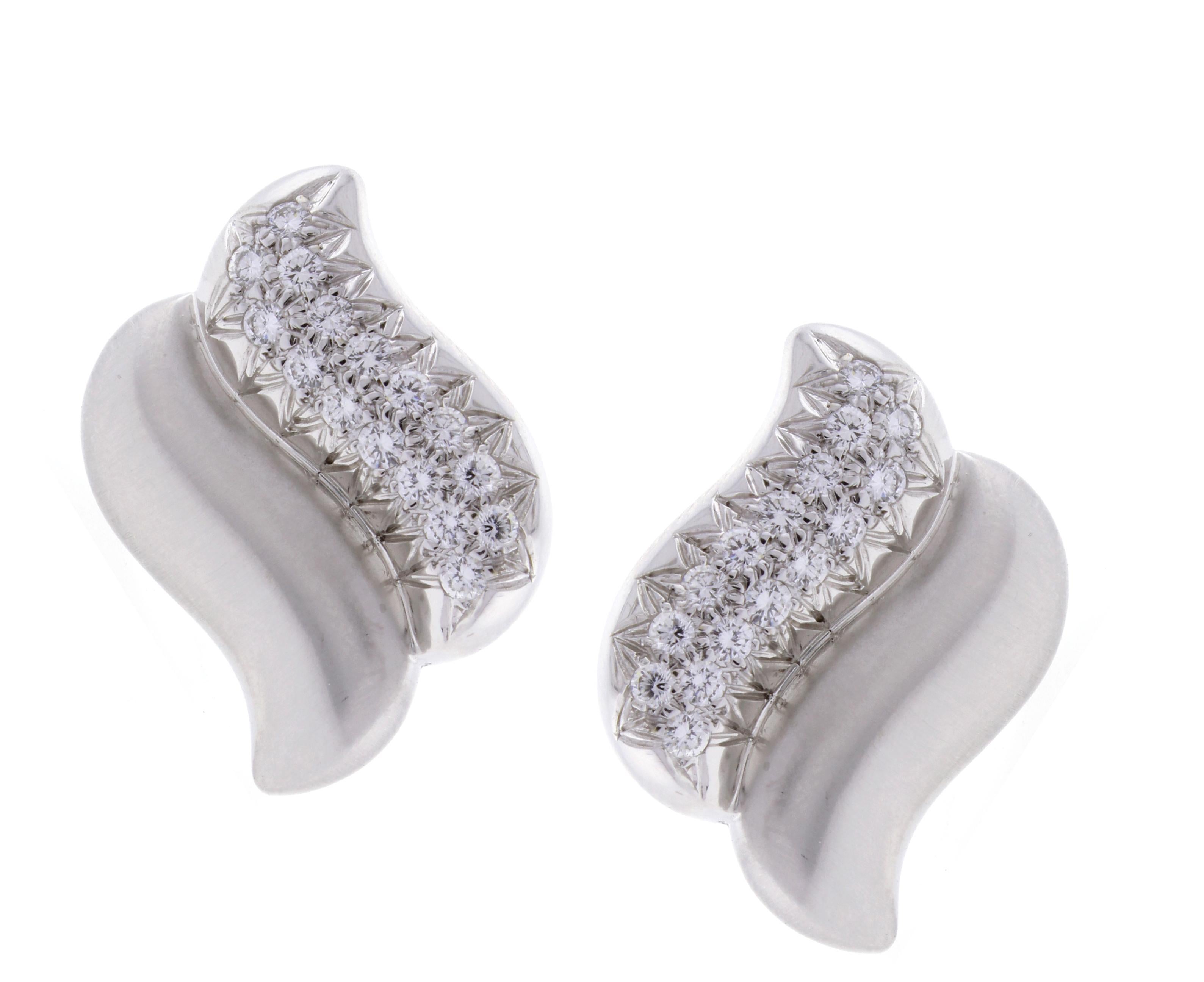 From Marlene Stowe, a pair of 18 karat white gold and diamond earrings. The earrings are designed as a double wave or 
