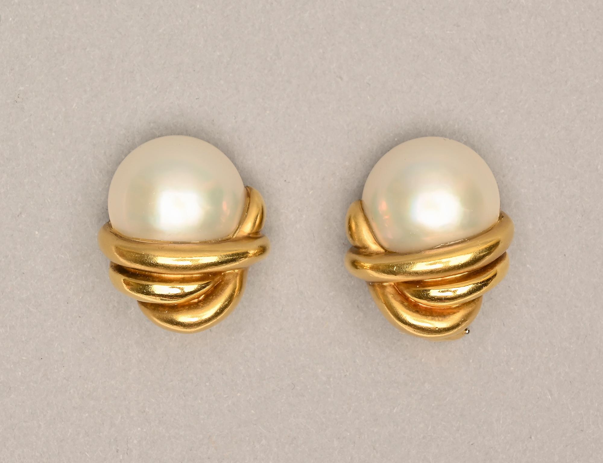 Half pearl earrings by Marlene Stowe with pearls that are 3/4