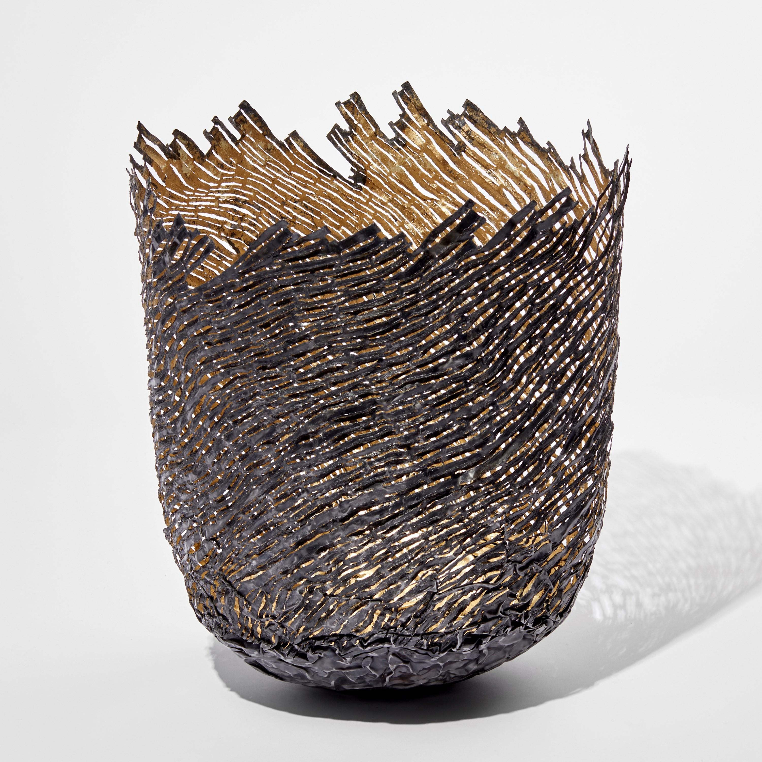 'Marloes Strata' is a unique sculptural vessel by the British artist, Claire Malet. Created from steel (re-formed steel can), 22 ct moon gold and 12 ct white gold.

Malet is an artist who works with precious, non-precious, found metals and