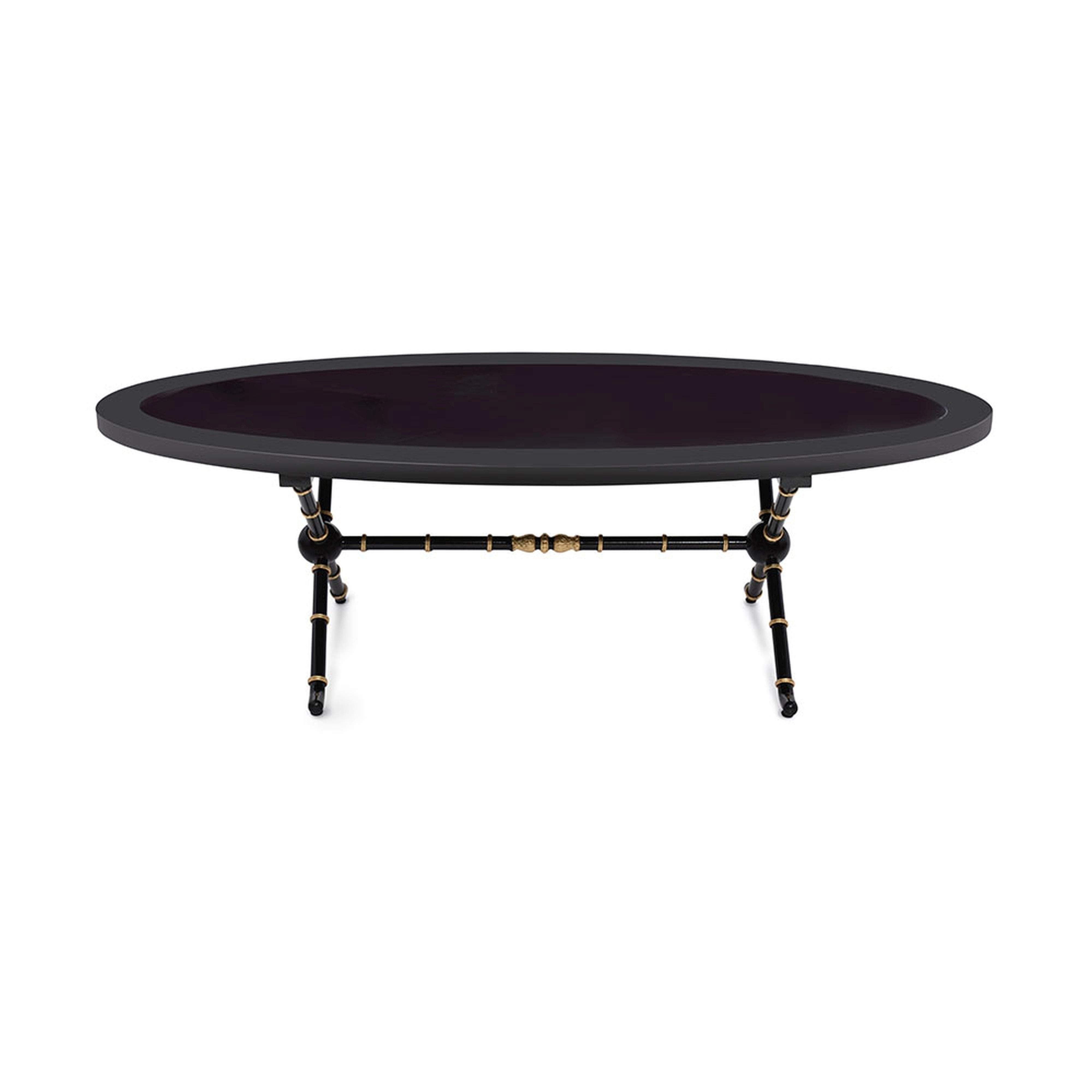 The Marmont coffee table is sophisticated as it is substantial. The distinctive, oval-shaped top is solemn and stabile, while the base offers a delicate bamboo effect in a hand-gilded leaf trim. Inlaid black tempered glass top. An aesthetically