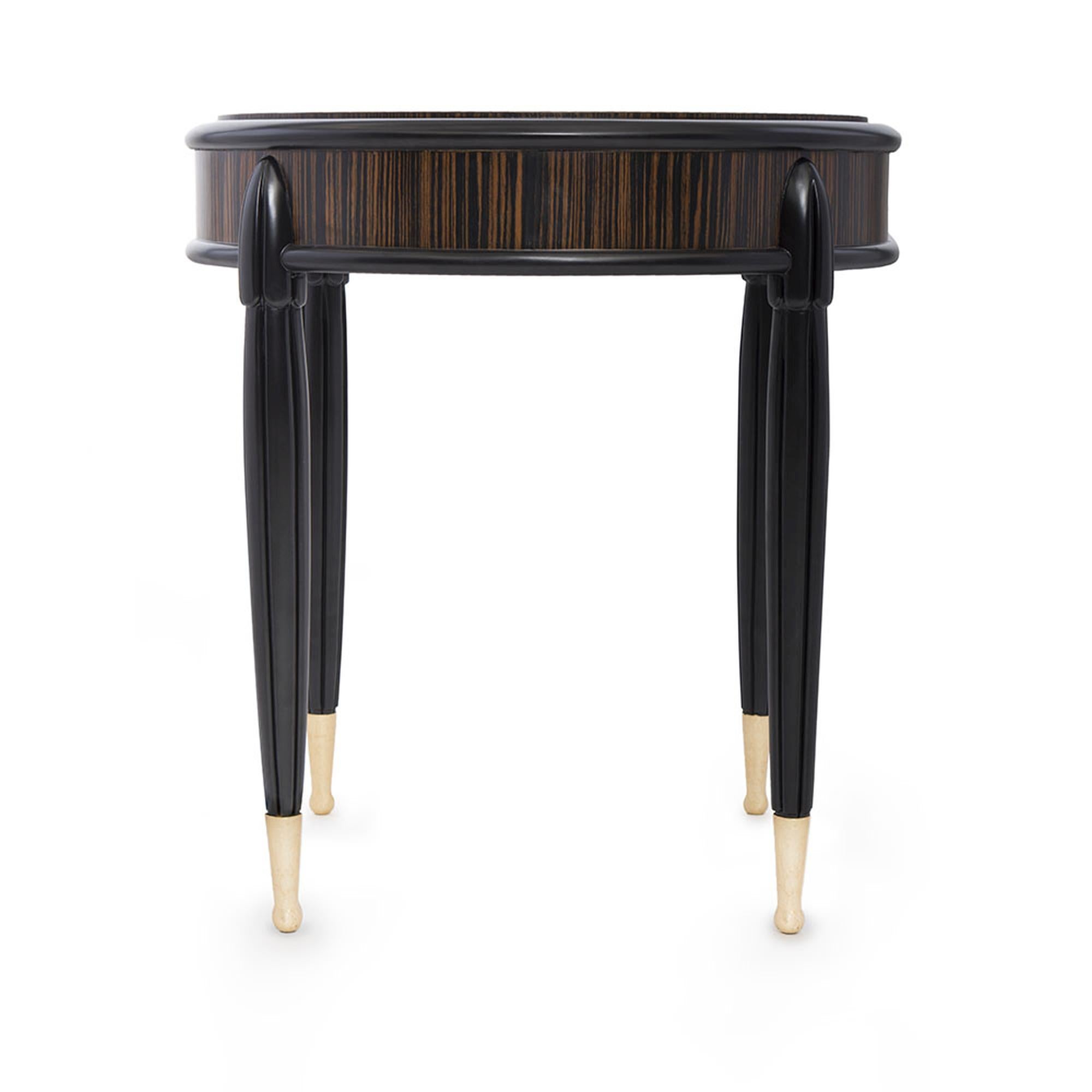 The Marmont Side Table is an elegant addition to any home. Crafted with a gorgeous ebony Macassar wood veneer top and four matte wood nished legs, this table is clean, stylish, and versatile. It is detailed with gold leaf accents at the base of the
