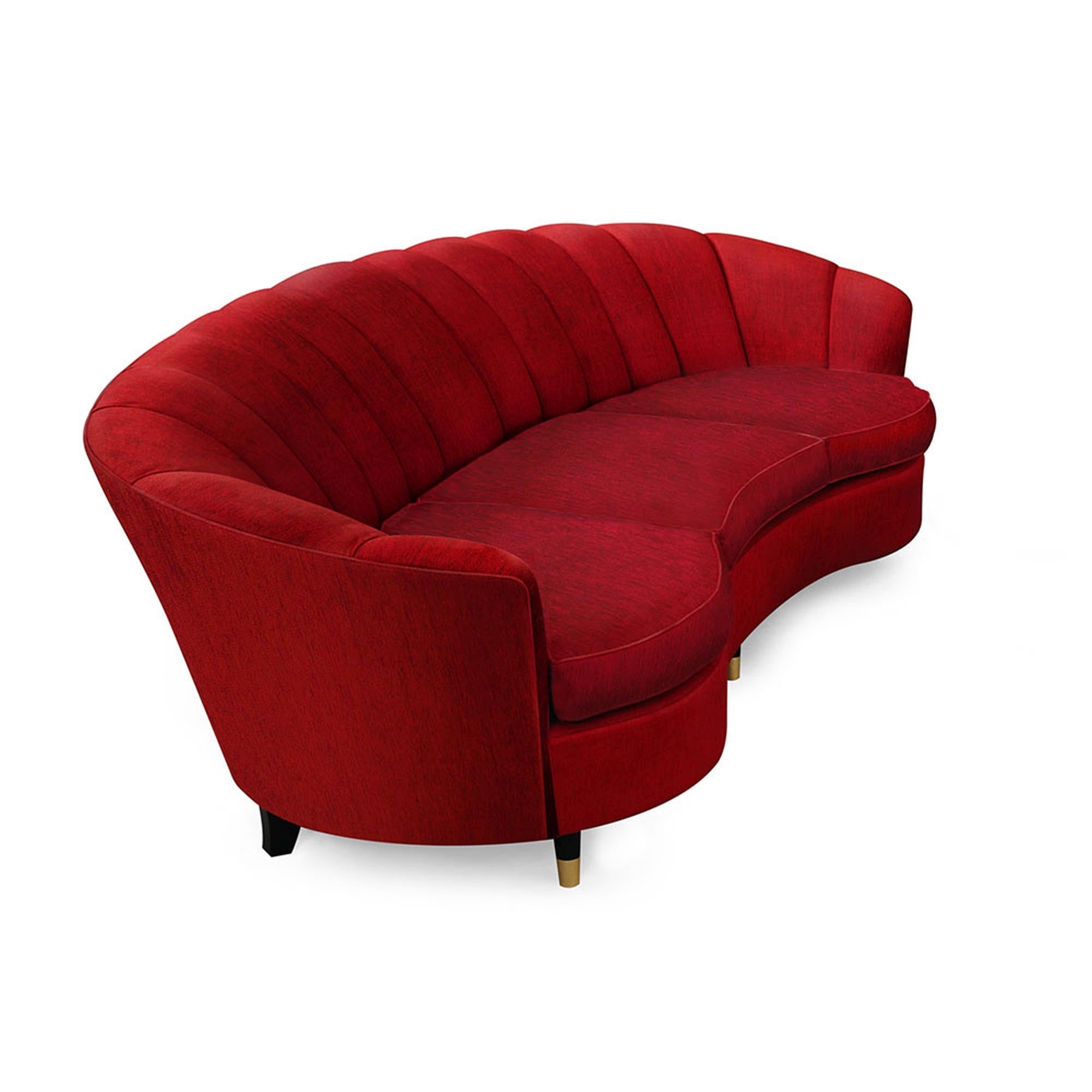 The Marmont Sofa is a majestic piece, reminiscent of a rare gem from the reveled old Hollywood era. With a curved frame and dramatic ared ends, this sofa is upholstered on all sides, features wide scalloped channel tufting, and offers an