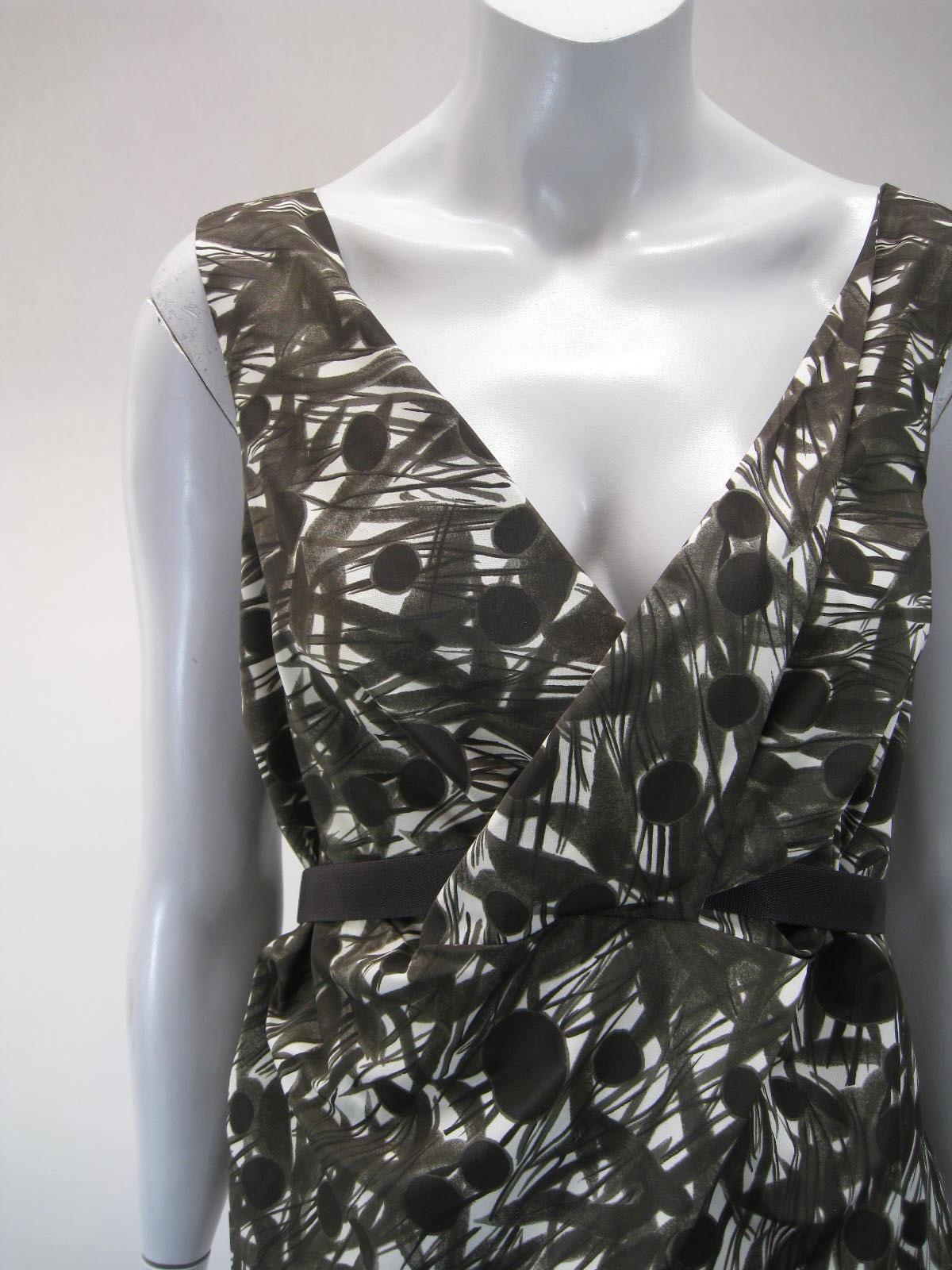 Marni sleeveless abstract print blouse.

Empire waist punctuated with removable strap belt.

Belt weaves through a hole in fabric.

Belt has nonadjustable snap closure.

Cross over bust line.

Shades of taupe/brown with off white.

Fabric is