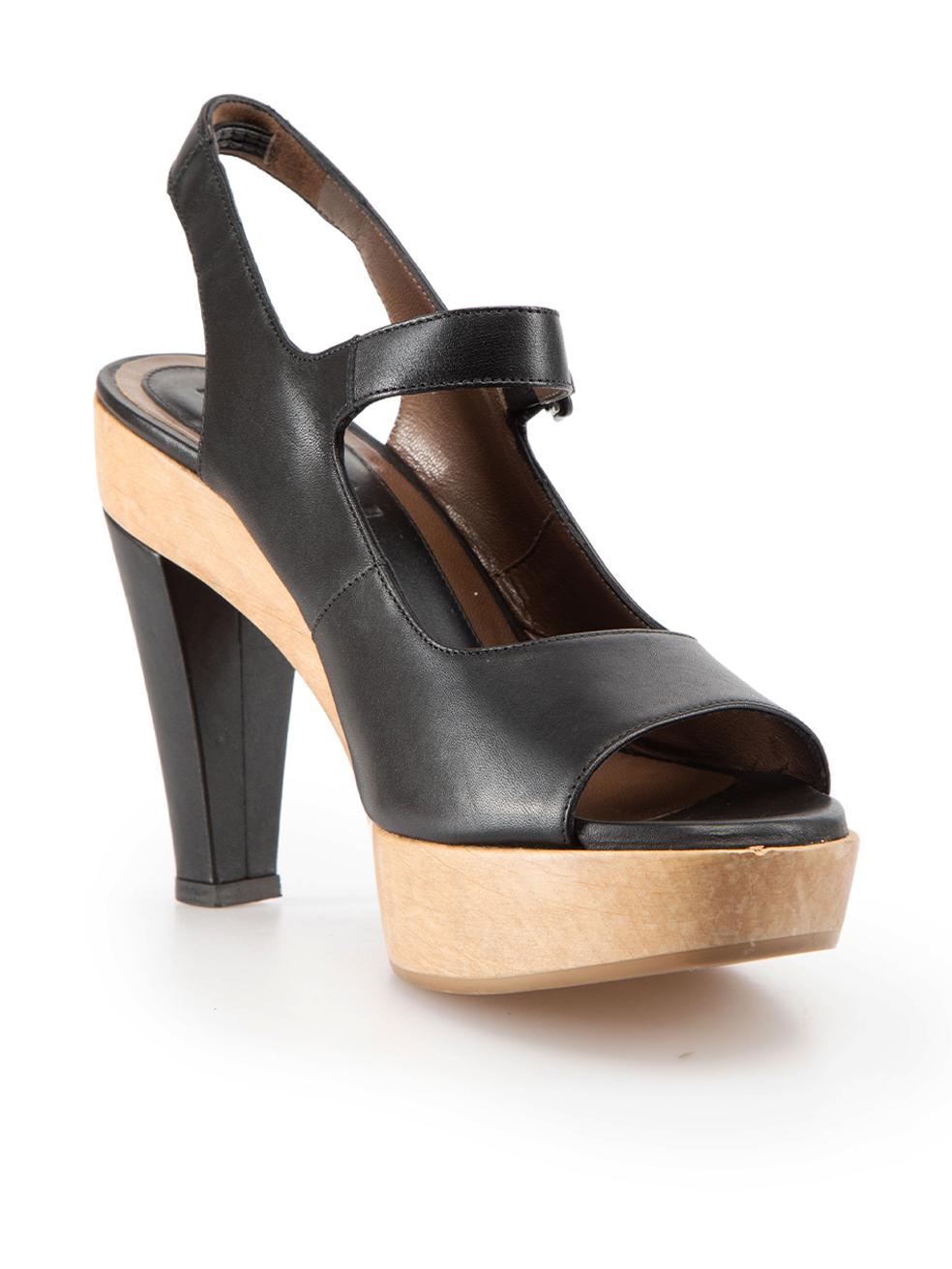 CONDITION is Very good. Minimal wear to shoes is evident. Minimal wear to both heels with light indents to the leather, and the wooden platforms of both shoes have water marks on this used Marni designer resale item. These shoes come with original