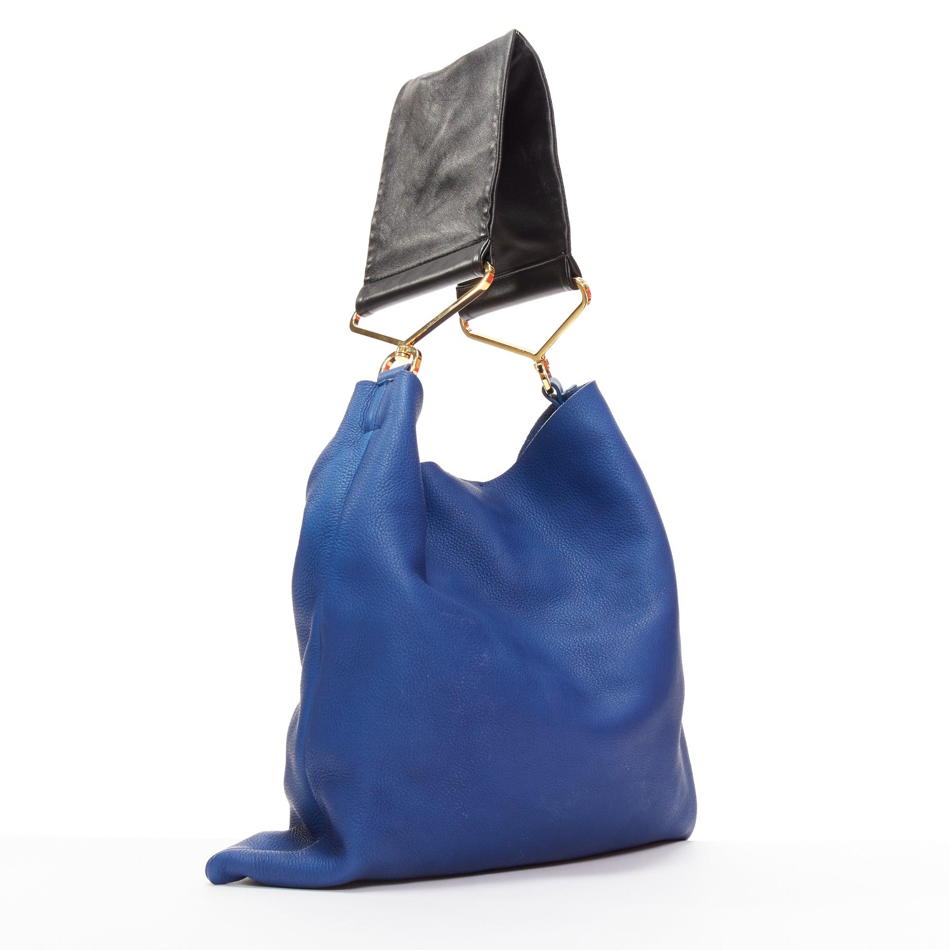 MARNI blue black textured leather gold hardware wide strap tote bag
Reference: NILI/A00057
Brand: Marni
Material: Leather
Color: Blue, Black
Pattern: Solid
Closure: Snap Buttons
Lining: Blue Leather

CONDITION:
Condition: Good, this item was