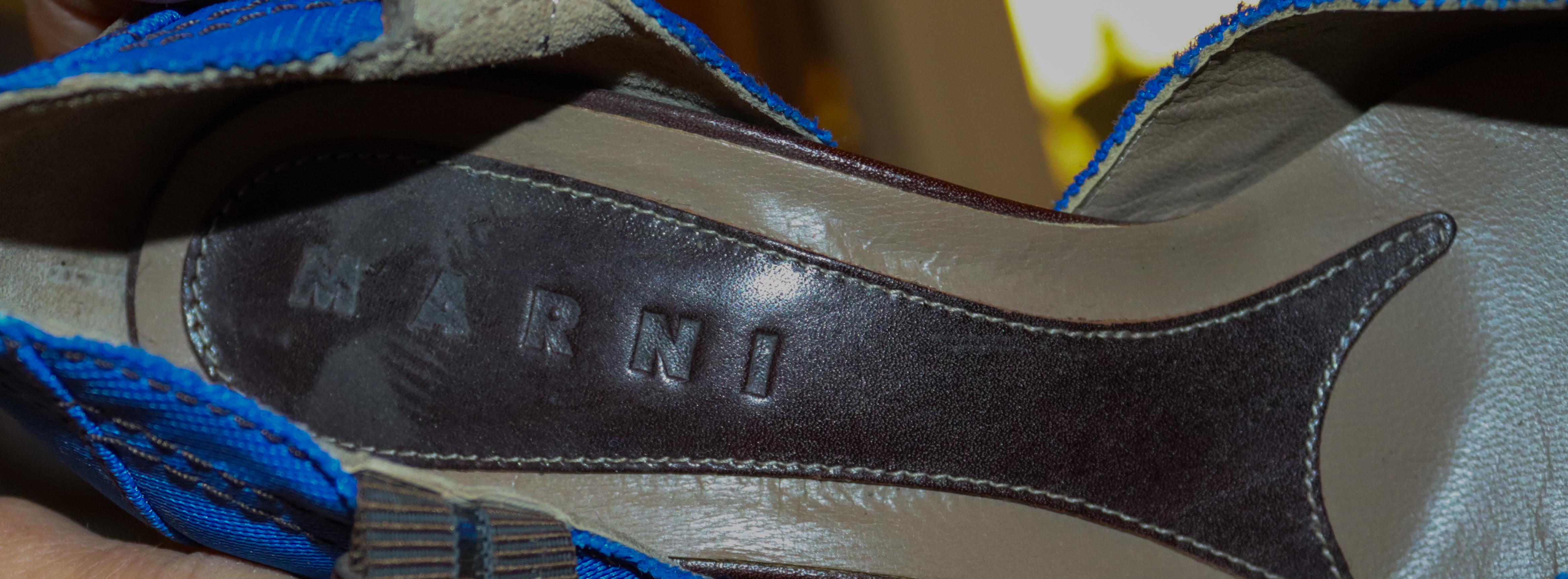 A fun pair of shoes by Marni.  The shoes are beautifully made and decorated with blue fabric uppers, a brown leather ankle strap and decoration on the toe.
Made in Italy,  Size 39, Heel height 3 1/2''