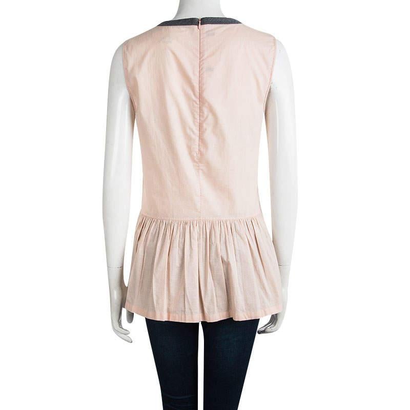 You'll love to make others blush with this stunning pink top from Marni. This lovely creation is made of 100% cotton and features a simole structured silhoutette. The sleeveless top also flaunts a round neckline, a gathered waist and a concealed zip