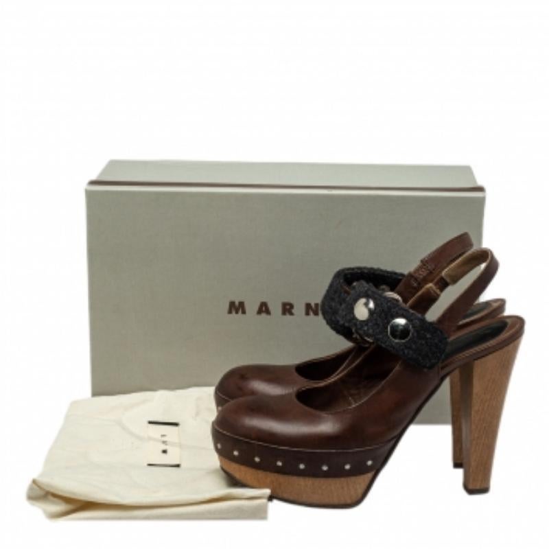 Stand tall and in style with this pair of pumps from Marni. Crafted from brown leather and black fabric, the fashionable pumps feature covered toes, back straps, platforms, and 12.5 cm heels. Style the pair with dresses or suits.