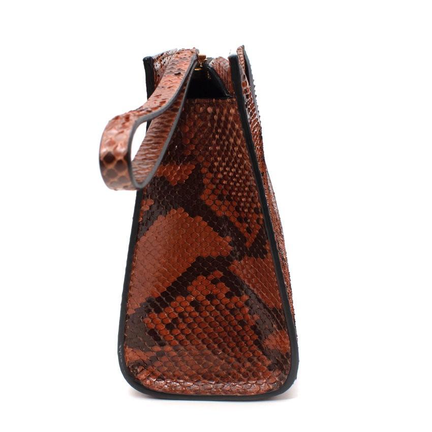 Marni Brown & Black Python Clutch Bag

- Crafted from snakeskin with a dark brown stain, allowing the natural patternation to shine through
- Grab bag, with small tonal wrist strap and gold-tone zip top
- Scooped-opening front slip pocket
- Lined in