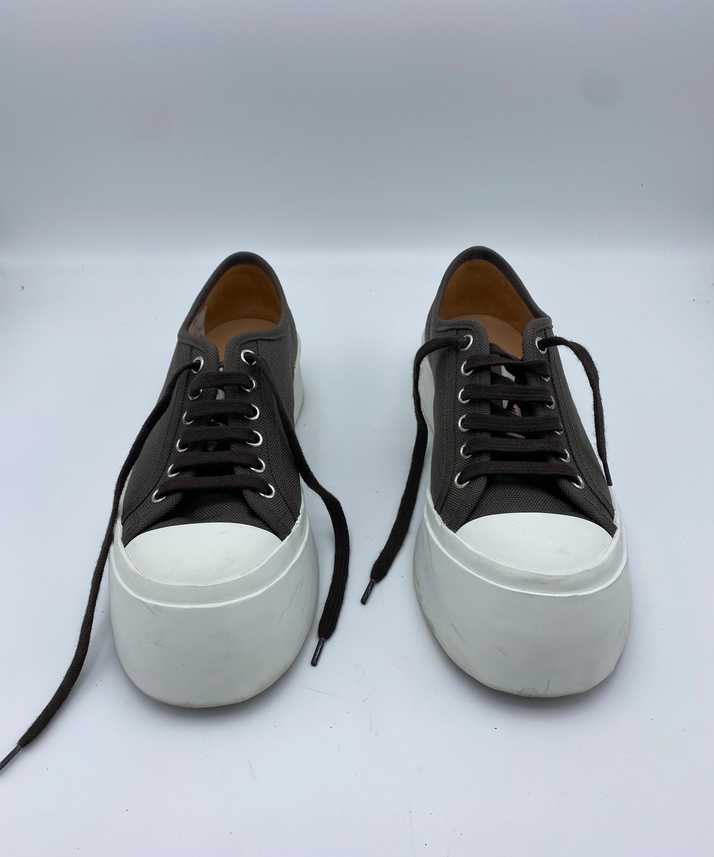 Product details:

The sneakers feature brown canvas with white rubber chunky platform. Heel height is 1 inch.