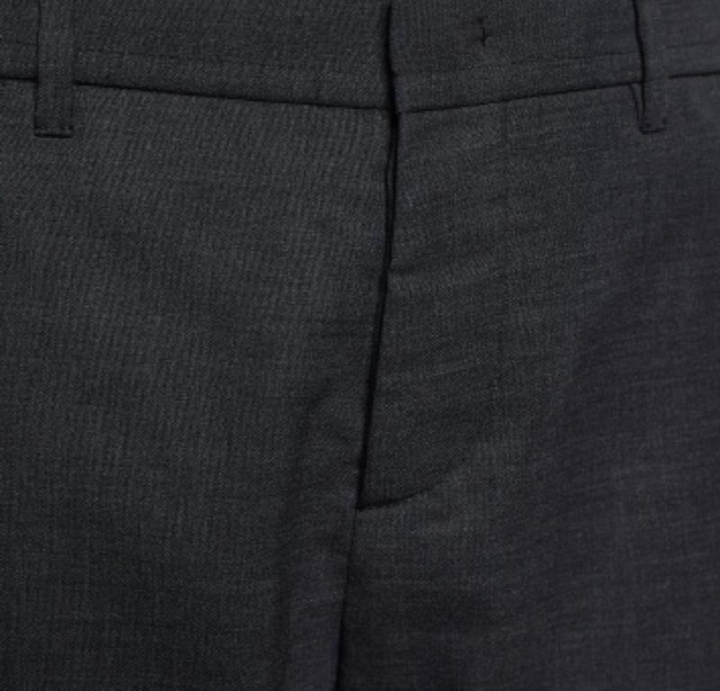 Trousers like these easily elevate the look of your formal outfit. These trousers from Marni will make you look positively sharp and classy. They are made from charcoal-grey wool fabric and showcase cuffed details, buttoned closure, and four
