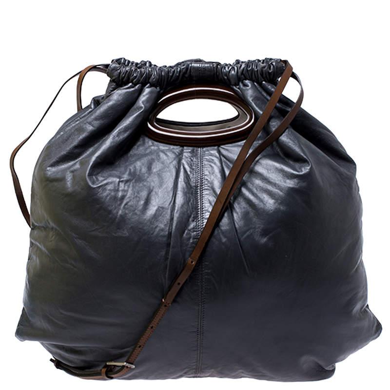 This wonderful Marni design is made from Nappa leather flaunting a dark grey shade. The bag has a slouchy shape with a drawstring closure that secures the nylon interior. It is complete with a shoulder strap and an in-built handle cutout.

