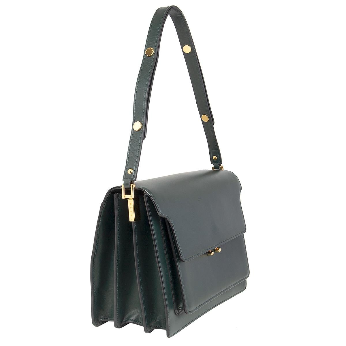 100% authentic Marni 'Large Trunk' shoulder bag in forest green calfskin featuring gold-tone hardware. Adjustable shoulder strap. Open pocket on the outside back. Closes with a push lock on the front. Open pocket on the outside front under the flap