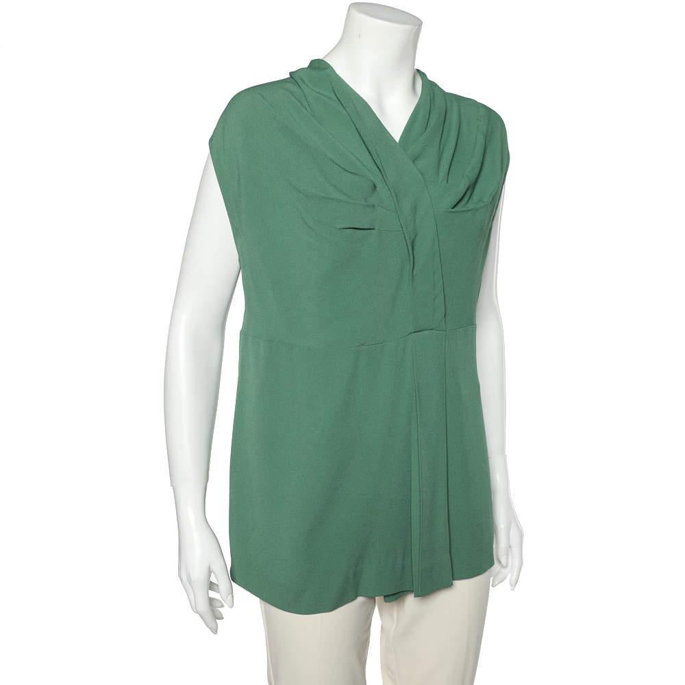 This top from the House of Marni will make you look beautiful. It is made from green crepe fabric and features draped formations on the front. For fastening it comes with a zipper. Look chic as you wear this top