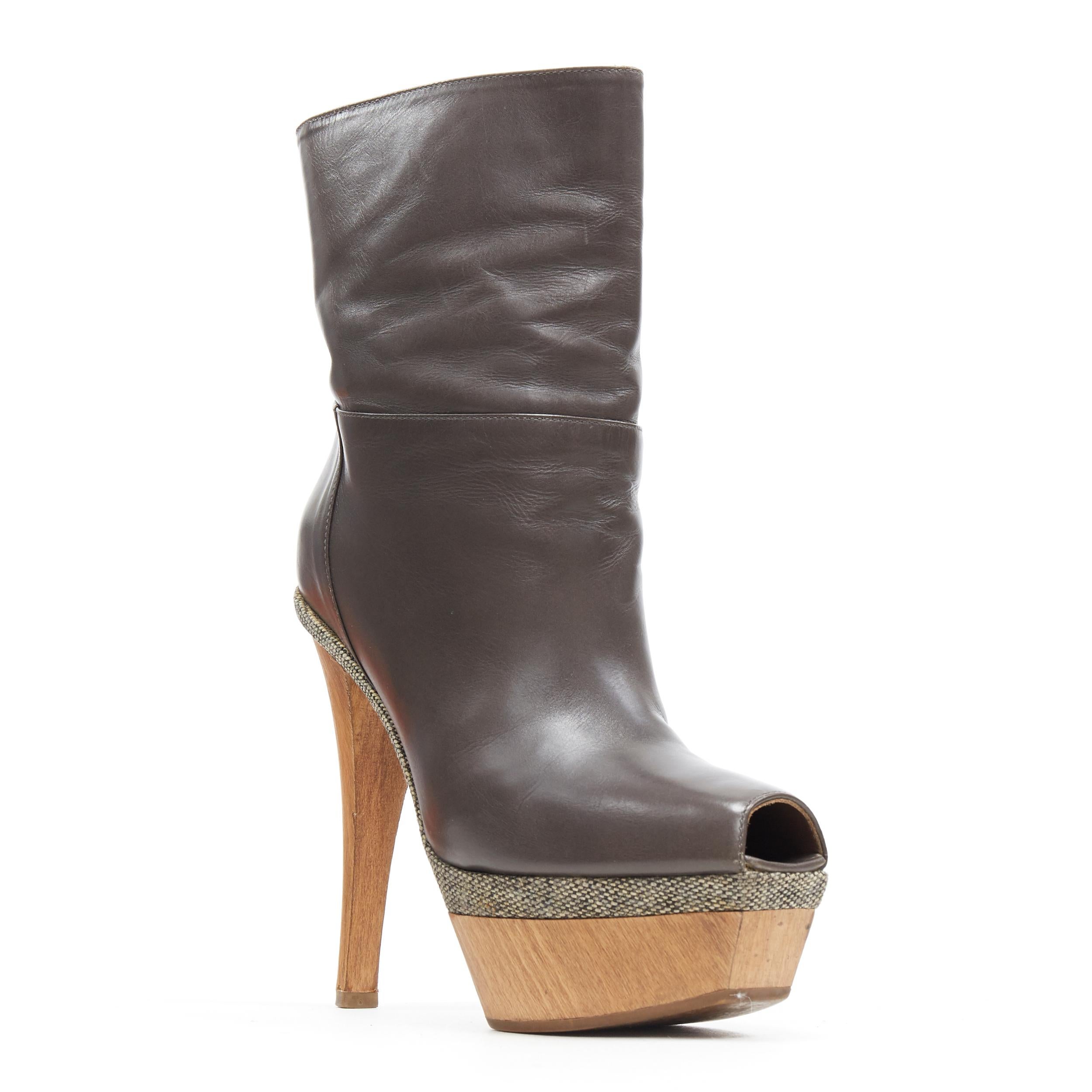 MARNI grey leather upper stacked wooden platform peep toe bootie heel EU36
Brand: Marni
Model Name / Style: Platfom boot
Material: Leather
Color: Grey
Pattern: Solid
Closure: Pull on
Extra Detail: Ultra High (4 in & Higher) heel height. Peep toe.