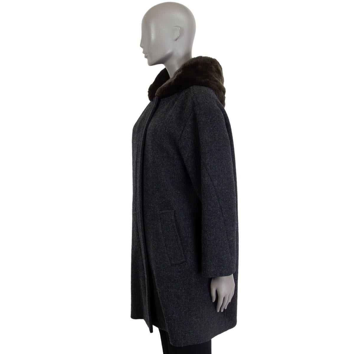 Marni fur hooded coat in dark grey wool (75%), rabbit rex fur (20%) and nylon (5%) with slit pockets. Closes on the front with a zipper and snap buttons. Lined in cotton (60%) and viscose (40%). Has been worn and is in excellent condition.

Tag Size