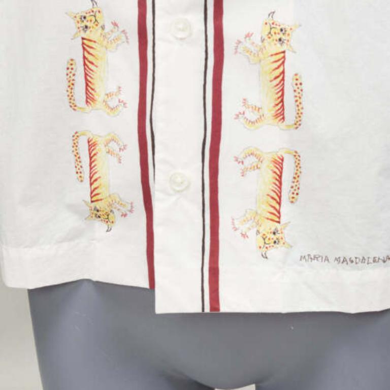 MARNI Maria Magdalena Suarez white cotton yellow tiger print shirt IT36 XXS
Reference: CELG/A00331
Brand: Marni
Model: Lily White
Collection: Maria Magdalena Suarez
Material: Cotton
Color: White, Multicolour
Pattern: Cartoon
Closure: Button
Extra