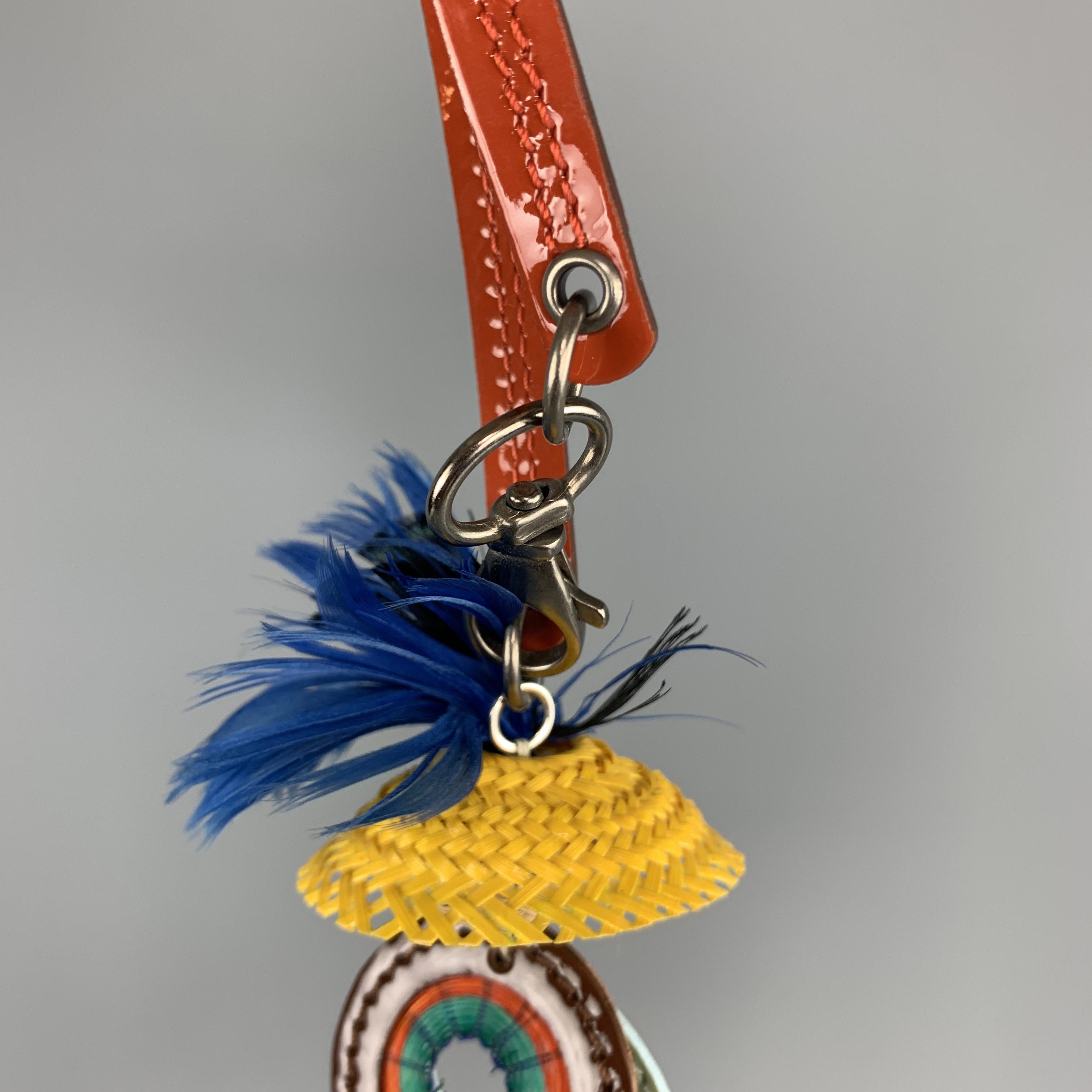 MARNI Key Ring Bag Charm comes in multi-color tones in mixed materials, with patent leather strap, blue feathers, straw, plastic and silver tone metal hardware, contrast stitching, and a lobster clasp closure. With dust bag and box.
 
Excellent