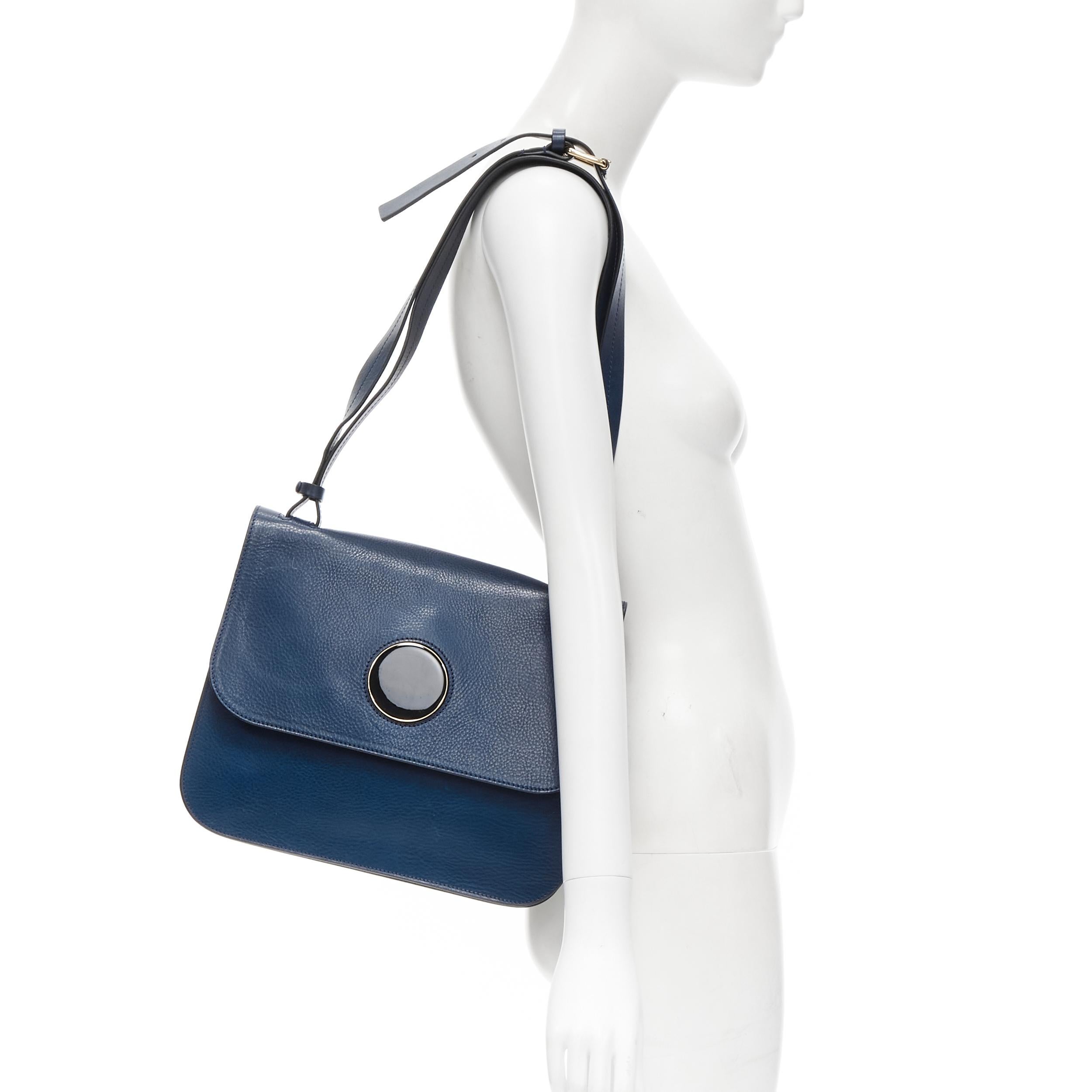 MARNI navy blue grained leather gold black circle push clasp shoulder flap bag 
Reference: CELG/A00007 
Brand: Marni 
Material: Leather 
Color: Blue 
Pattern: Solid 
Closure: Lock 
Extra Detail: Gold hardware with black resin design. Inner zip