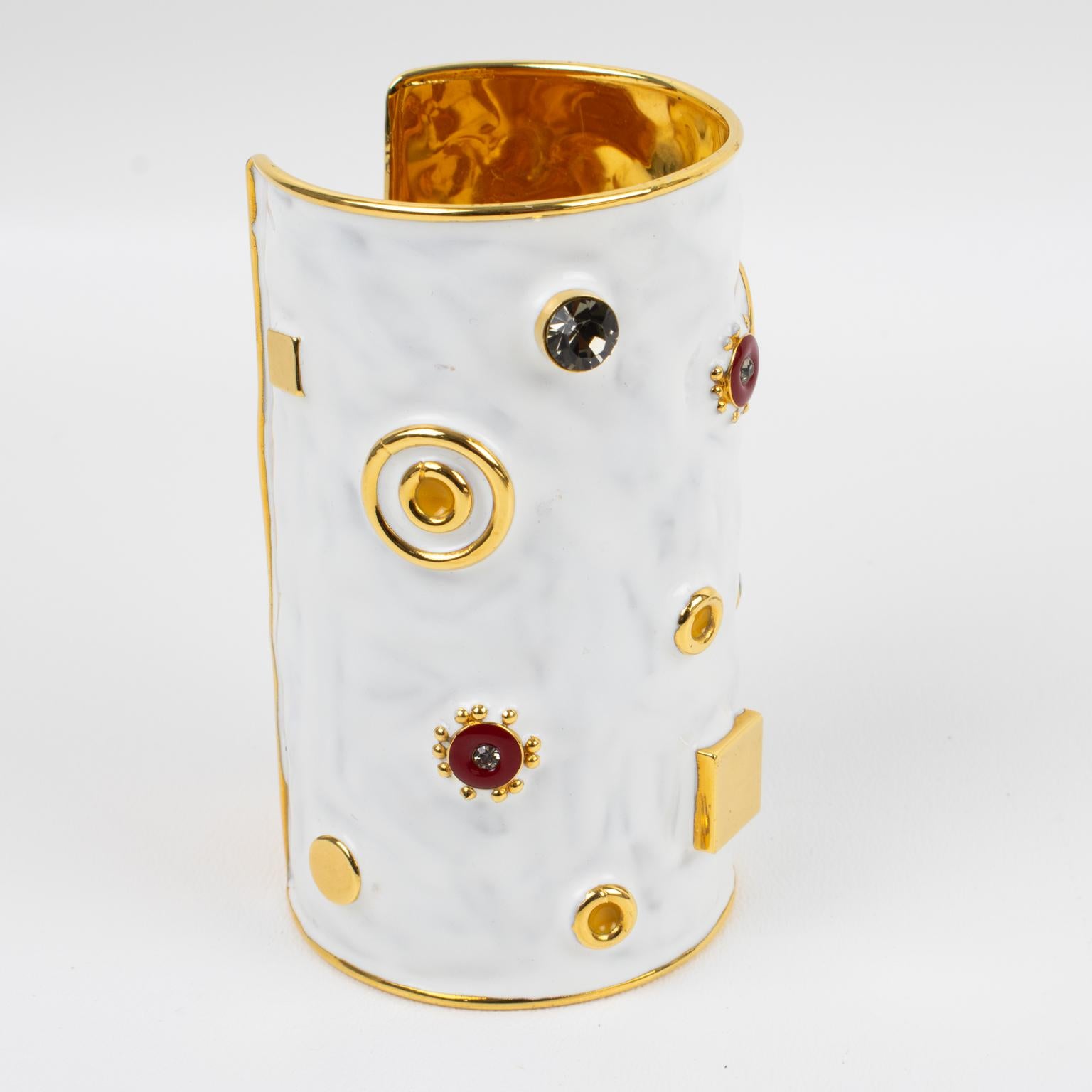 Stunning Marni jeweled cuff bracelet bangle. Oversized cuff shape in shiny gilt metal with hand-made feel, topped with white enameling and ornate with gilt metal cabochons, red enamel, and crystal rhinestones. Engraved on the inside Marni - Made in