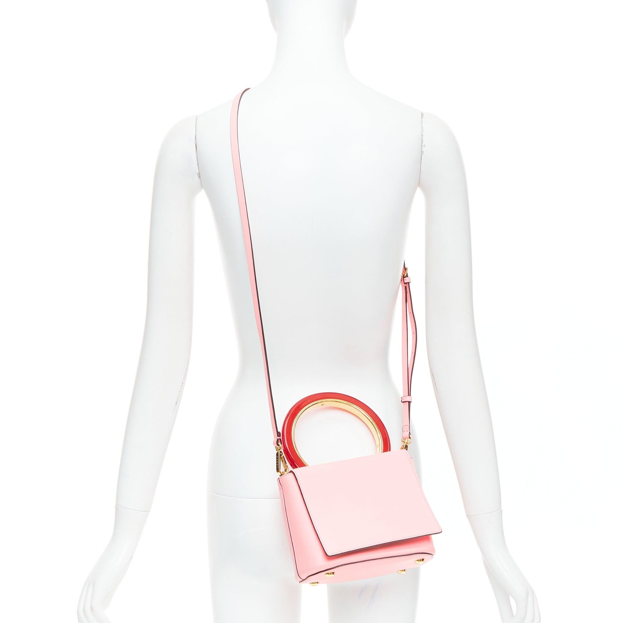 MARNI Pannier red resin handle pink leather flap crossbody bag
Reference: KYCG/A00158
Brand: Marni
Model: Pannier
Material: Leather
Color: Pink, Red
Pattern: Solid
Closure: Magnet
Lining: Pink Leather
Extra Details: Instil a dose of minimalistic