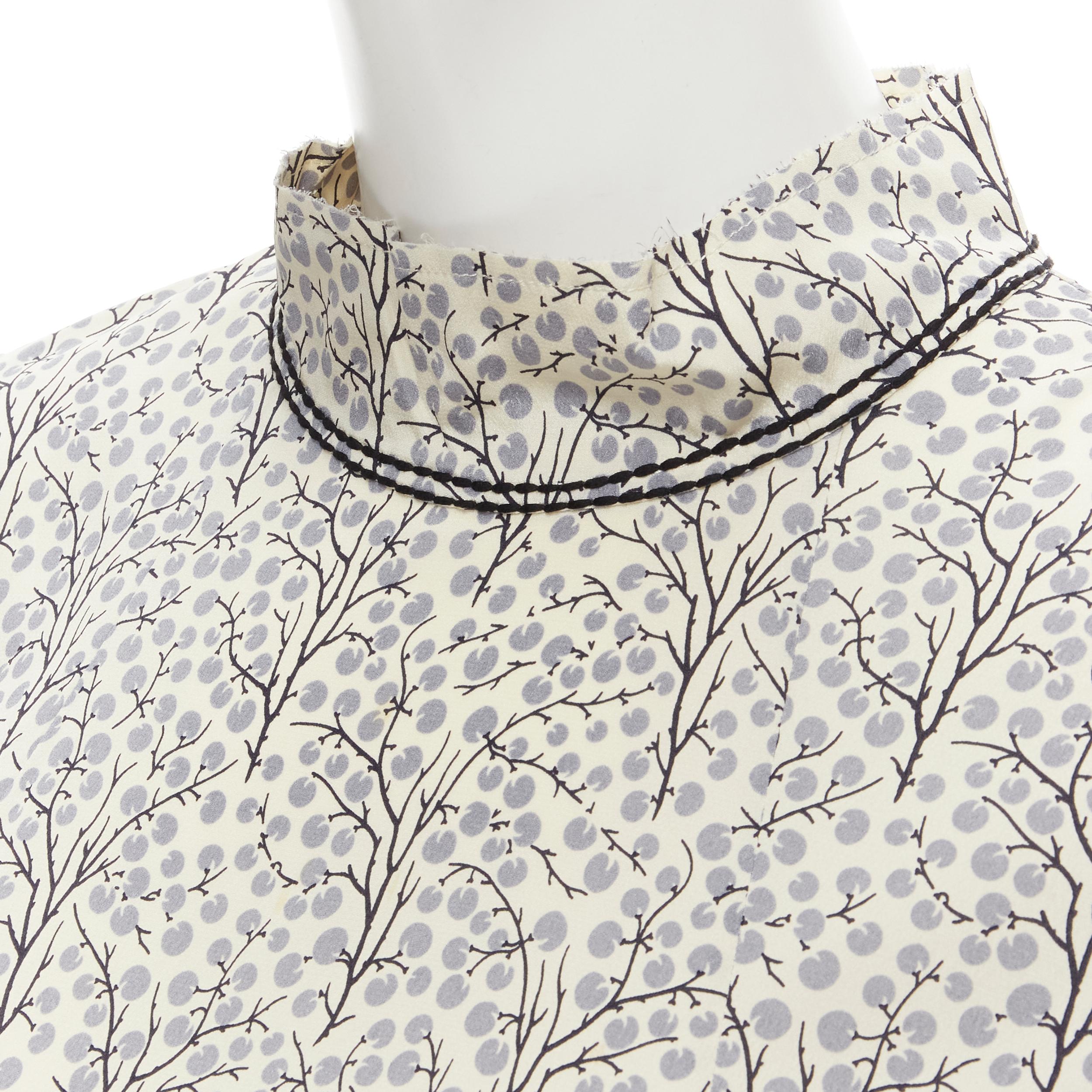 MARNI pastel yellow grey tree illustration print silk high collar tunic top IT38 XS 
Reference: MELK/A00150 
Brand: Marni 
Material: Silk 
Color: Yellow 
Pattern: Abstract 
Closure: Zip 
Extra Detail: Stitching detail at cuff and collar. Dual pleat