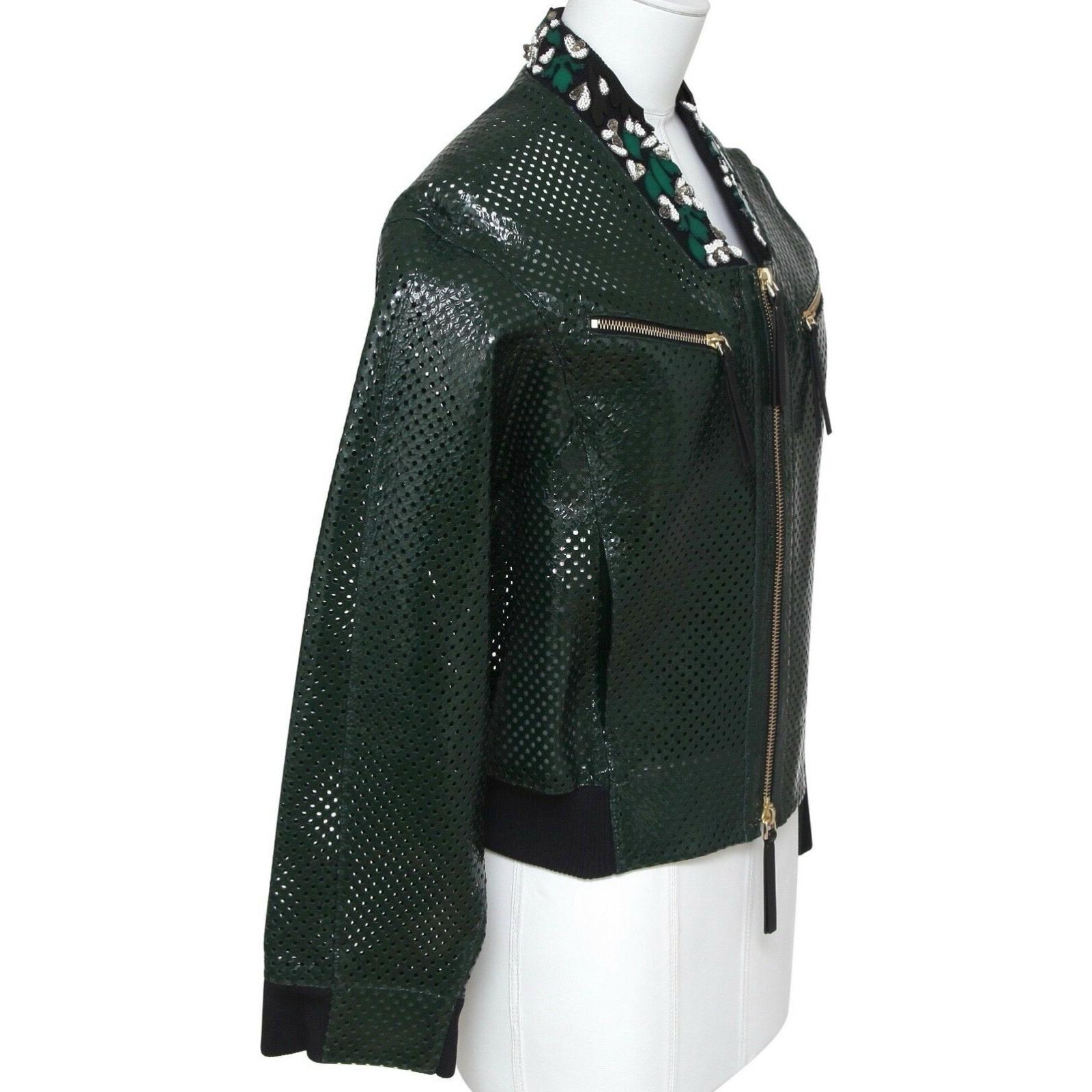 GUARANTEED AUTHENTIC MARNI PERFORATED LEATHER BOMBER JACKET WITH FLORAL EMBELLISHED ACCENT

Retail excluding sales taxes $3,370

Design:
 • Classic bomber style perforated leather jacket in a rich emerald green color.
 • Floral glass beads and