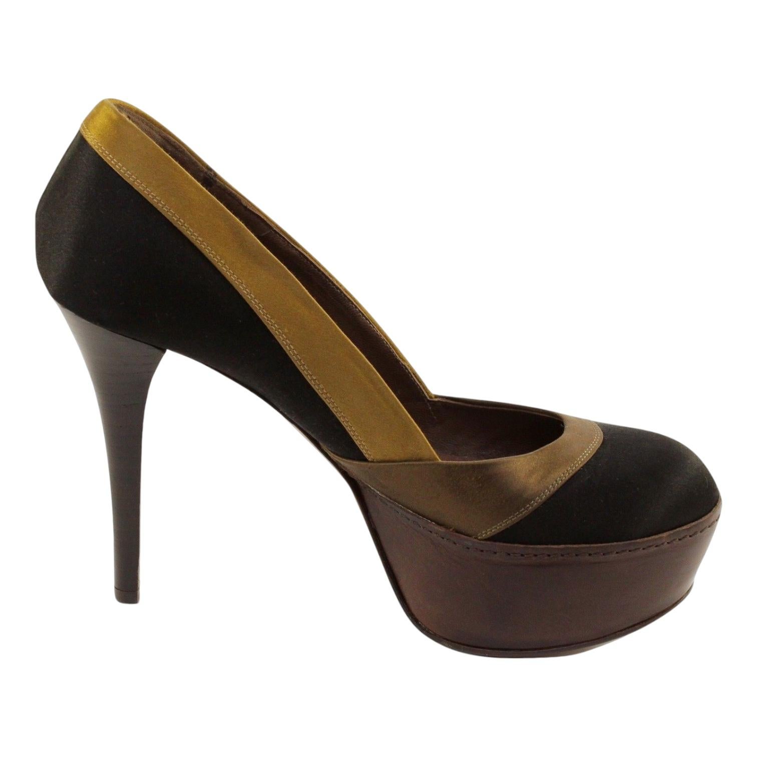 GUARANTEED AUTHENTIC MARNI SATIN COLOR BLOCKED PLATFORM PUMP


Material: Satin, Leather

Design:
 - Stunning color blocked satin platform pumps in a rich black, olive green and brown colors.
 - Platform is covered in a distressed treated brown