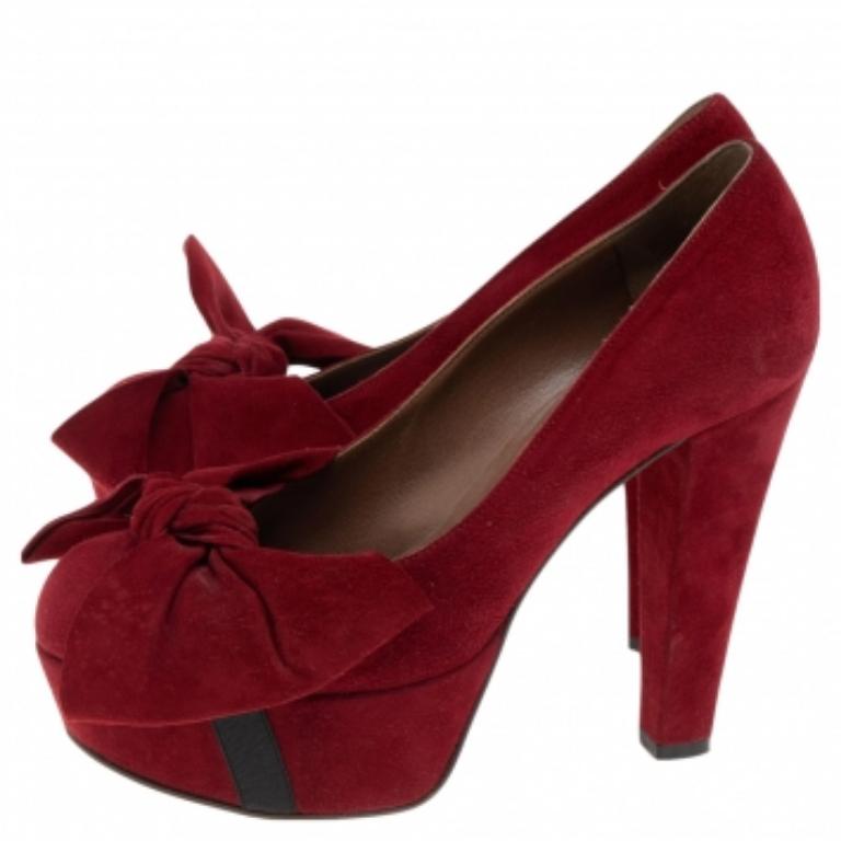 These pumps from Marni will add a defining edge to your feet. They are crafted using red suede on the exterior and come with a bow accent on the front, platforms, and gorgeous heels. As you match them with your outfit, feel glamorous and stylish as