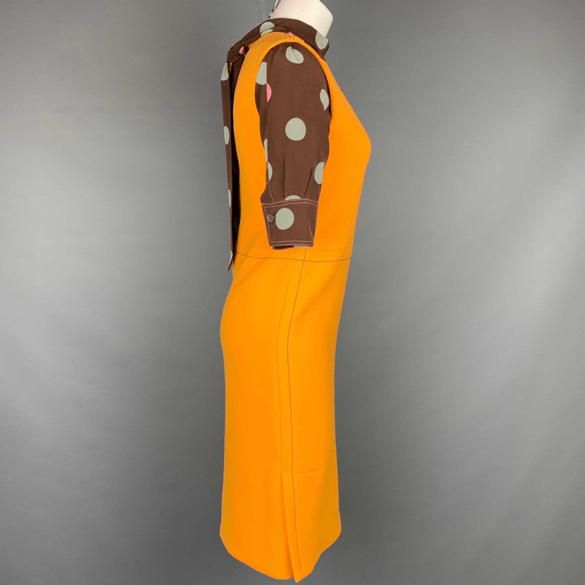 MARNI dress comes in a orange & brown polka dot virgin wool with a silk layer featuring a back tie up design, contrast stitching, and a back buttoned closure. Made in Italy.

Very Good Pre-Owned Condition.
Marked: 36

Measurements:

Shoulder: 13.5