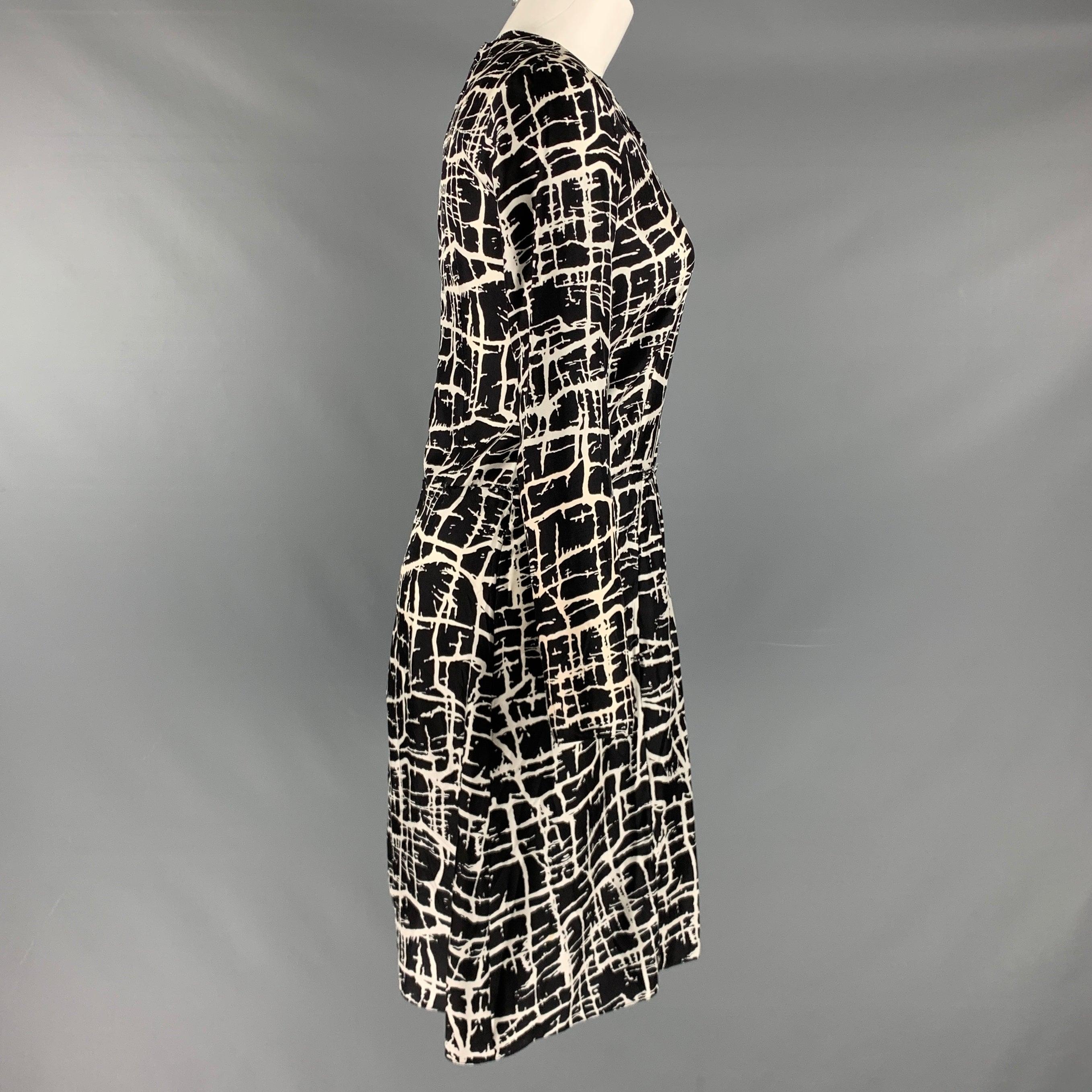 MARNI dress comes in a black and white woven material featuring a A-line design, long sleeves, and a zip up closure. Made in Italy.Excellent Pre-Owned Condition.  

Marked:   2 

Measurements: 
 
Shoulder: 16.5 inches Bust: 34 inches Hip: 36 inches