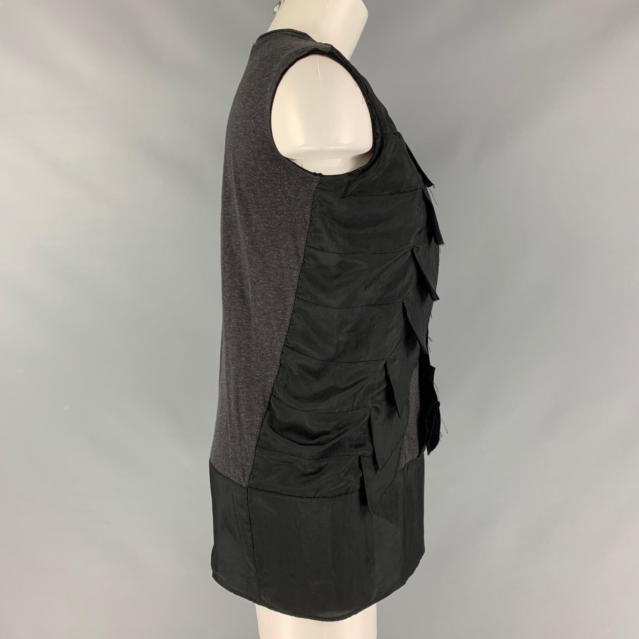 MARNI sleeveless blouse comes in a black triacetate jersey featuring a ruffled front detail. Made in Italy.Very Good Pre-Owned Condition. Minor mark at front. 

Marked:   38 

Measurements: 
 
Shoulder: 15.5 inches Bust: 37 inches Length: 27 inches 