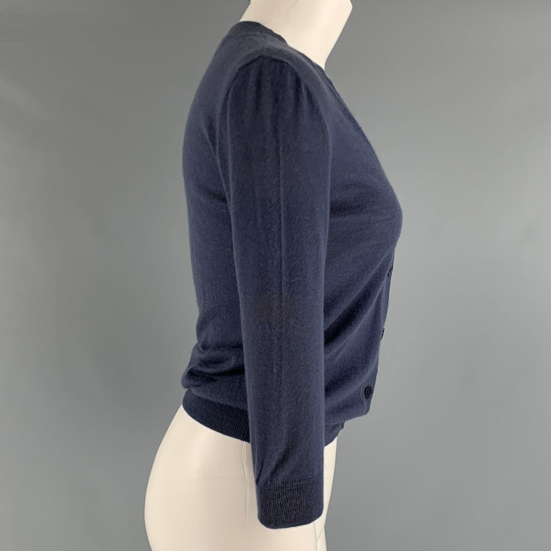 MARNI cardigan comes in a blue cashmere knitted material featuring 3/4 sleeves, v-neck, and a buttoned closure. Made in ItalyExcellent Pre-Owned Condition. 

Marked:   2 

Measurements: 
 
Shoulder: 15.5 inches Bust: 34 inches Sleeve: 18 inches