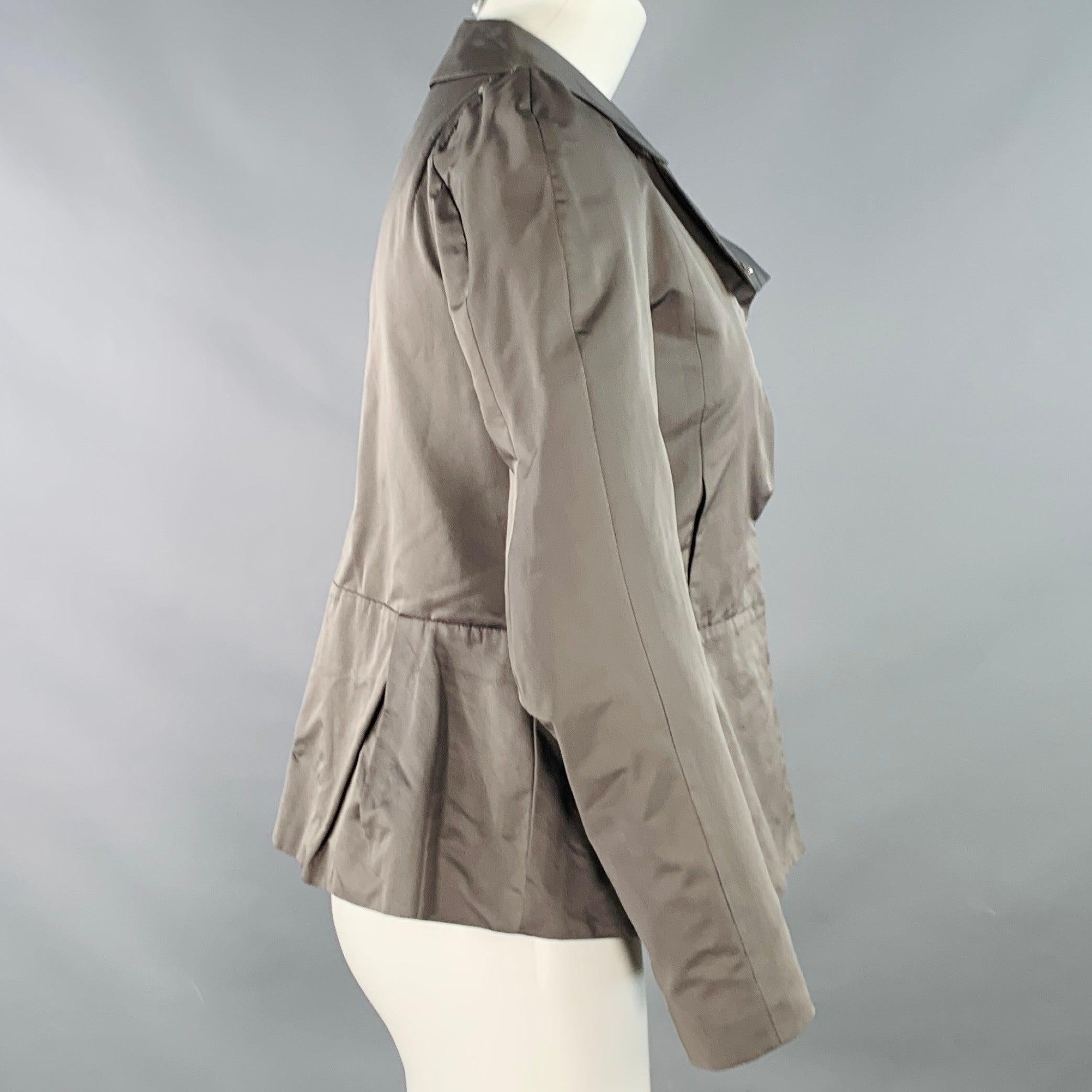 MARNI jacket in a grey polyester woven techno fabric featuring long sleeves, peplum hem, and hidden snap closure. Made in Italy.Excellent Pre-Owned Condition. 

Marked:   IT 38 

Measurements: 
 
Shoulder: 11.75 inches Bust: 34 inches Sleeve: 23.5