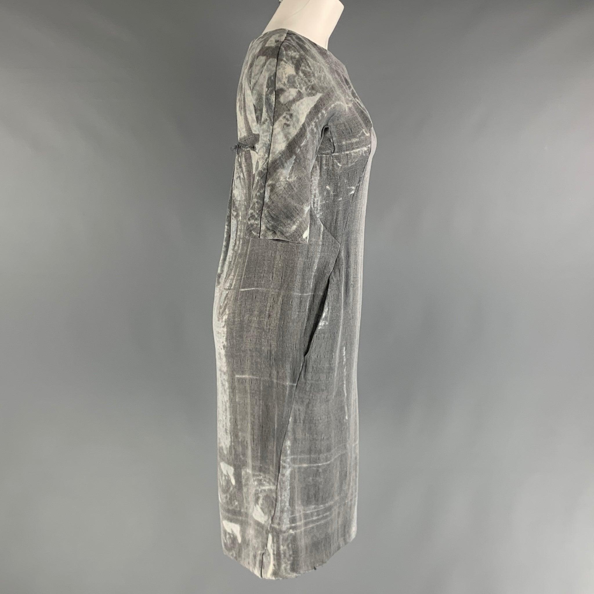 MARNI dress comes in a grey and silver polyester and silk woven material featuring pockets, and marbled print, and scoop neck. Made in Italy.Very Good Pre-Owned Condition. 

Marked:  38 

Measurements: 
 
Shoulder: 15 inches Bust: 32 inches Waist: