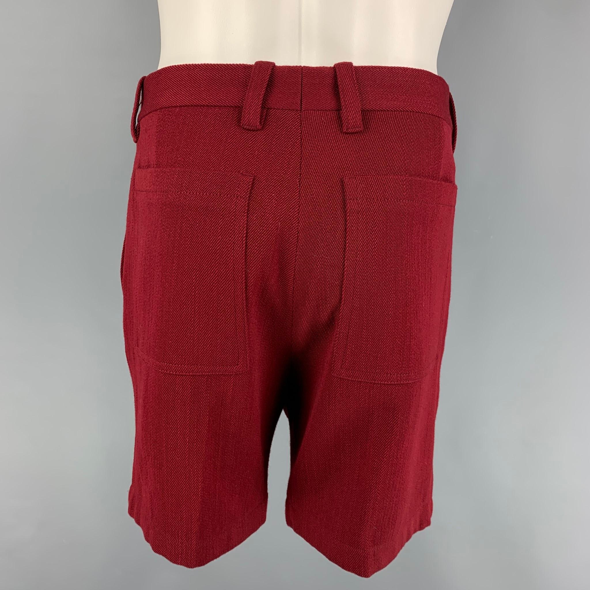 MARNI shorts comes in a burgundy wool  featuring a flat front and a button fly closure. Made in Italy. 

Very Good Pre-Owned Condition.
Marked: 48

Measurements:

Waist: 32 in.
Rise: 14 in.
Inseam: 7 in. 