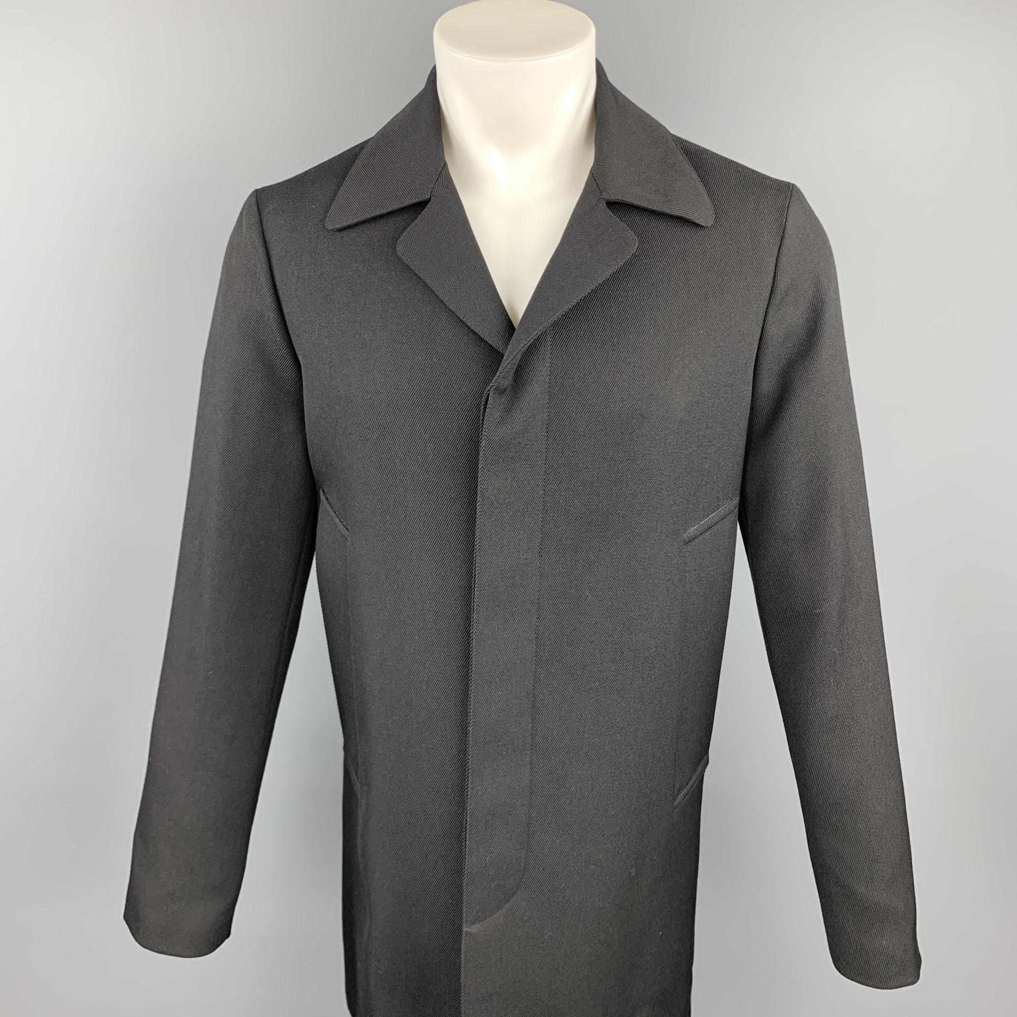 MARNI coat comes in a black wool featuring a notch lapel style, slit pockets, and a hidden button closure. Made in Italy.

Excellent Pre-Owned Condition.
Marked: IT 44

Measurements:

Shoulder: 17 in. 
Chest: 42 in.
Sleeve: 27 in.
Length: 35.5 in. 