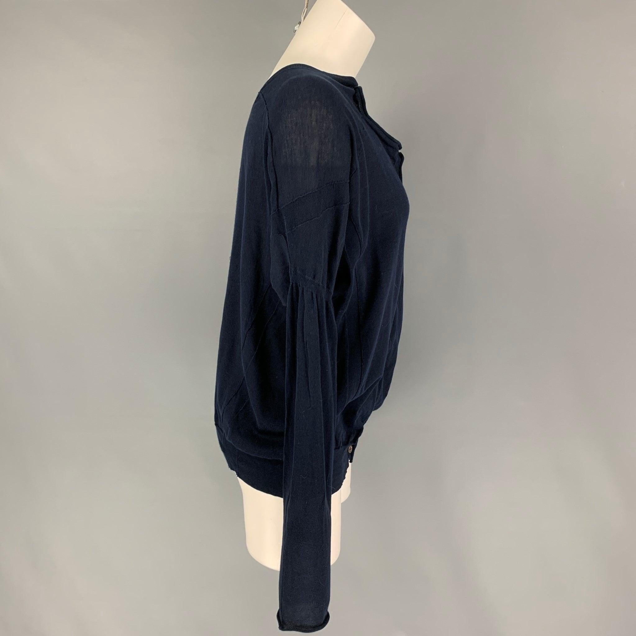 MARNI pullover comes in a navy cotton featuring dolman sleeves, front cut-out design, and a buttoned closure. Made in Italy.
Very Good
Pre-Owned Condition. 

Marked:   40 

Measurements: 
 
Shoulder: 16.5 inches  Bust: 46 inches  Sleeve: 24 inches 