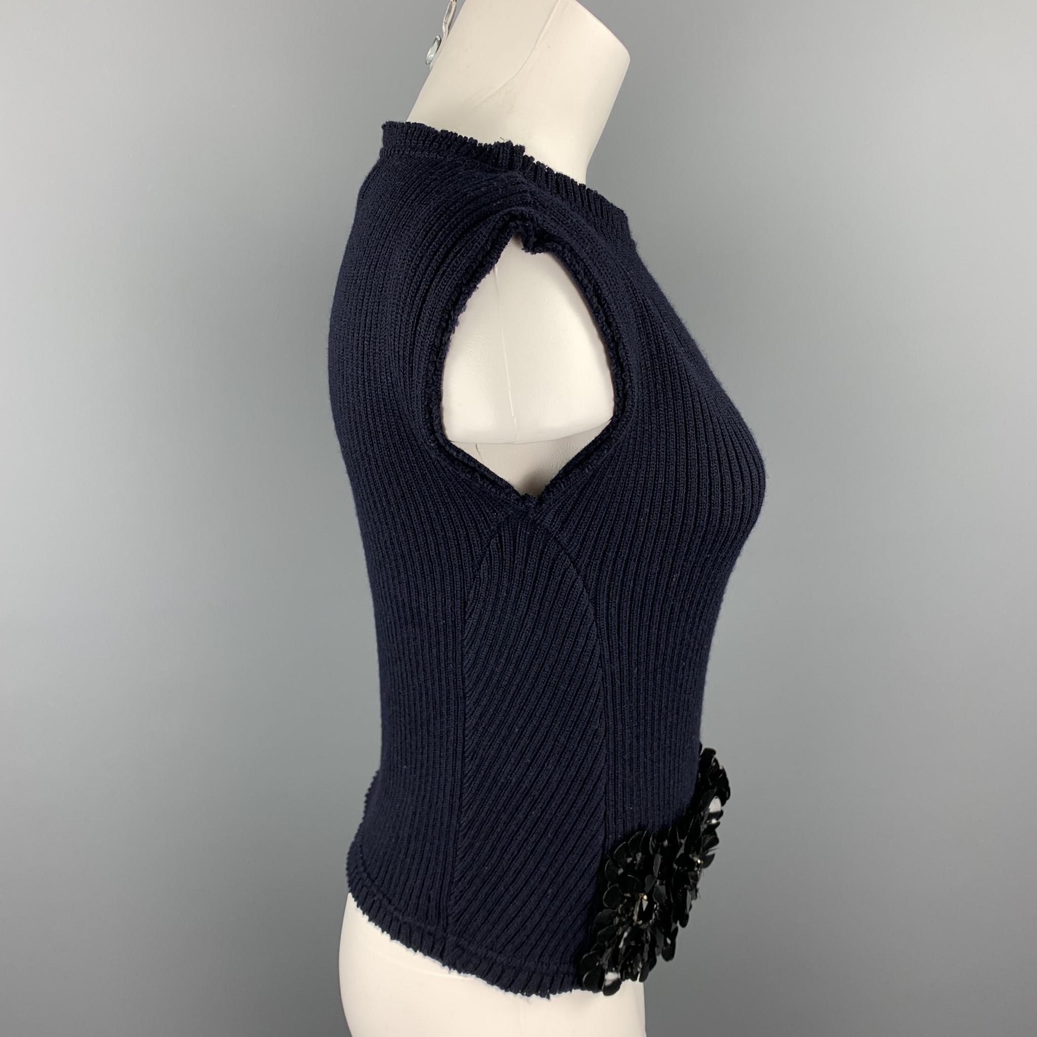 MARNI sleeveless dress top comes in a navy knitted wool with floral applique details featuring a loose neck. Made in Italy.

Excellent Pre-Owned Condition.
Marked: IT 38

Measurements:

Shoulder: 17 in. 
Bust: 32 in. 
Length: 18.5 in.