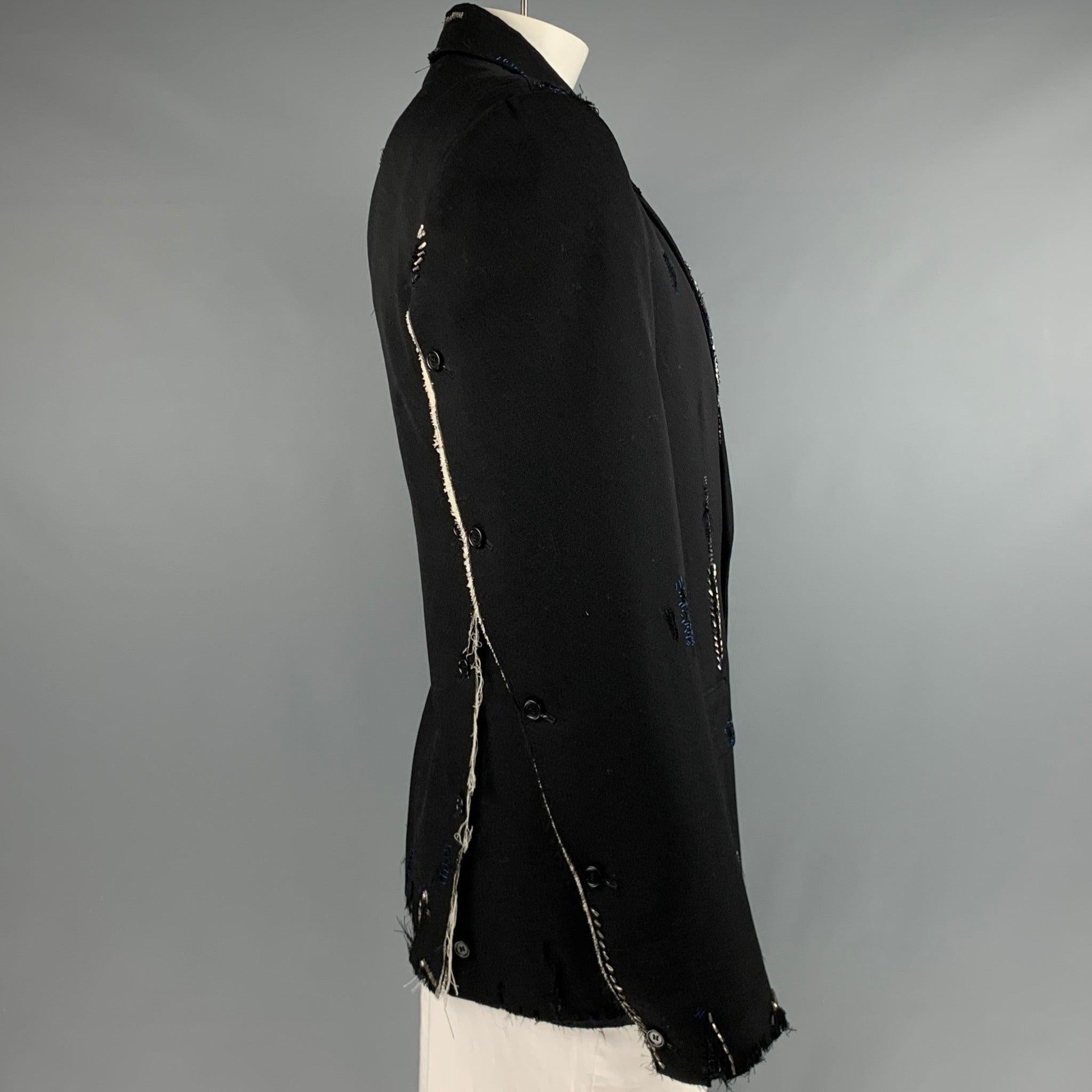 MARNI sport coat in a black wool fabric featuring distressed unfinished style with visible mending-style beading, notch lapel, and double button closure. Sleeves and back unbutton all the way to shoulder, converting the piece to a stunning and