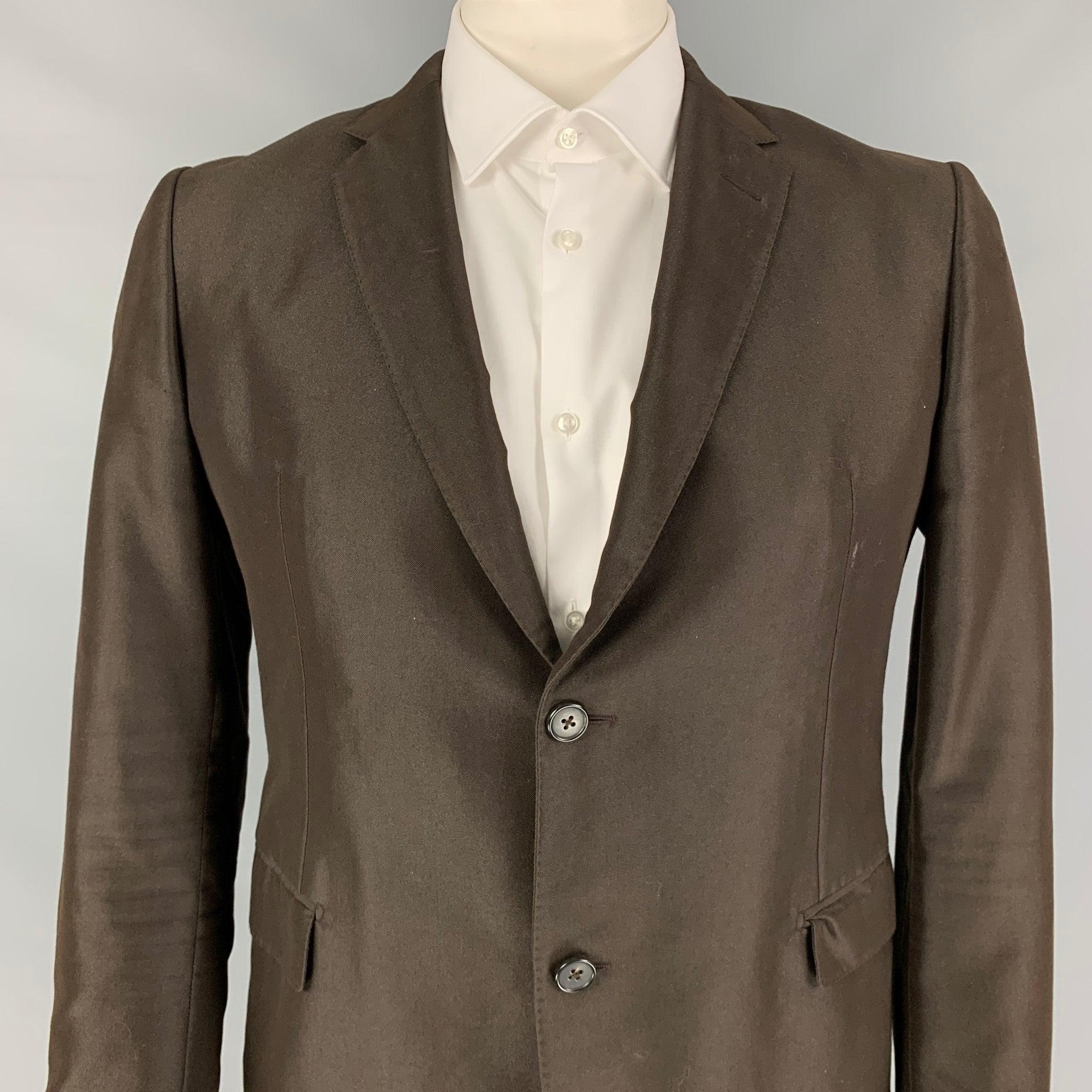 MARNI sport coat comes in a brown cotton / polyester with a full liner featuring a notch lapel, flap pockets, single back vent, and a double button closure. Made in Italy.
Very Good
Pre-Owned Condition. 

Marked:   52 

Measurements: 
 
Shoulder:
18