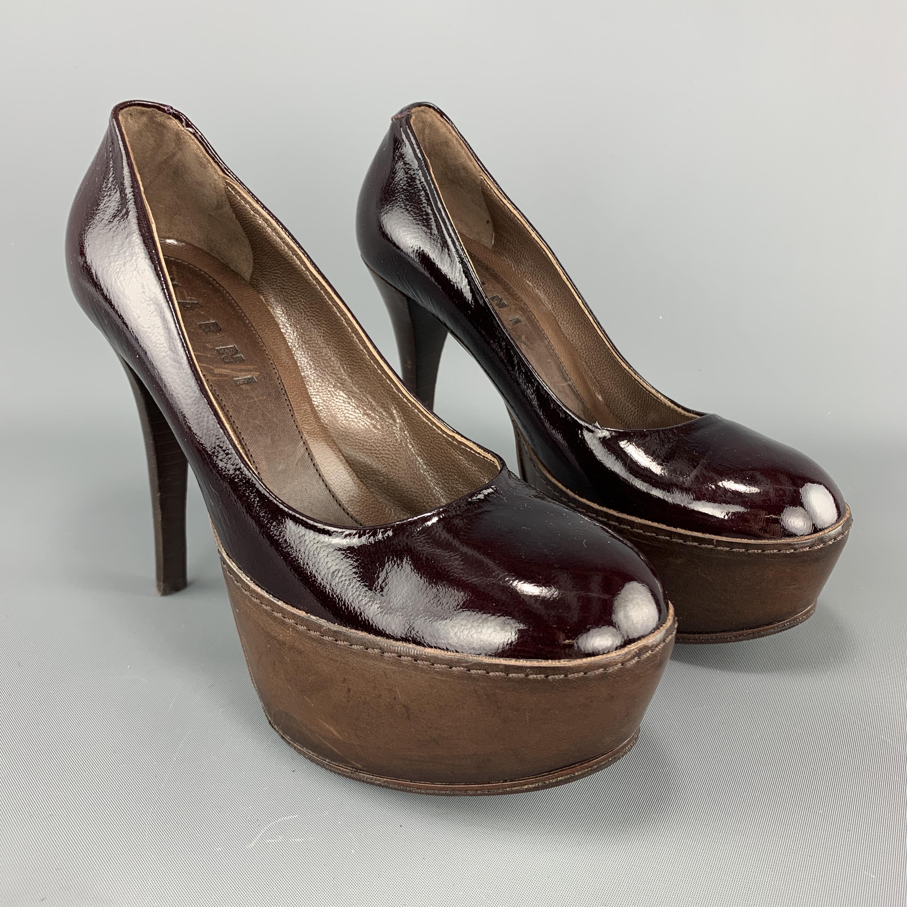 MARNI pumps come in burgundy patent leather with a round toe, brown leather covered platform, and stacked stiletto heel. Made in Italy. 

Very Good Pre-Owned Condition.
Marked: IT 36

Measurements:

Heel: 4.5 in.
Platform: 1.5 in.