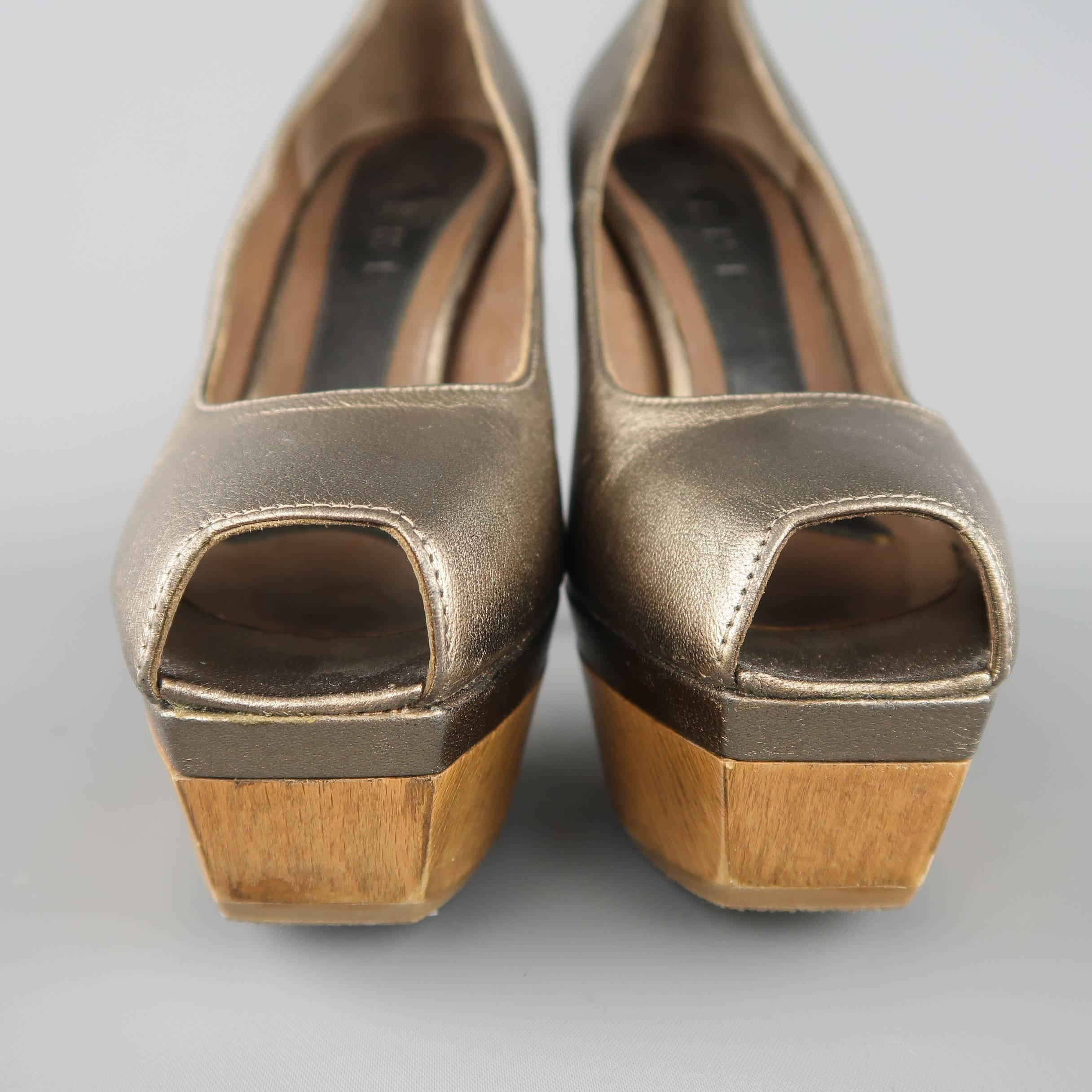 MARNI pumps come in metallic taupe leather with a peep toe and wooden heel and platform.
 
Excellent Pre-Owned Condition.
Marked: IT 35
 
Measurements:
 
Heel: 5 in.
Platform: 1.5 in
