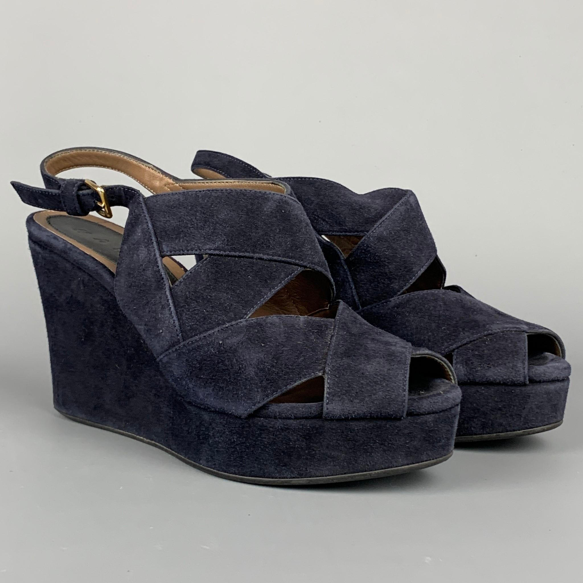 MARNI sandals comes in a navy suede featuring a ankle strap, platform, and a wedge heel. Made in Italy

Very Good Pre-Owned Condition. Light fading at exterior.
Marked: 36

Measurements:

Heel: 4 in.
Platform: 1 in. 