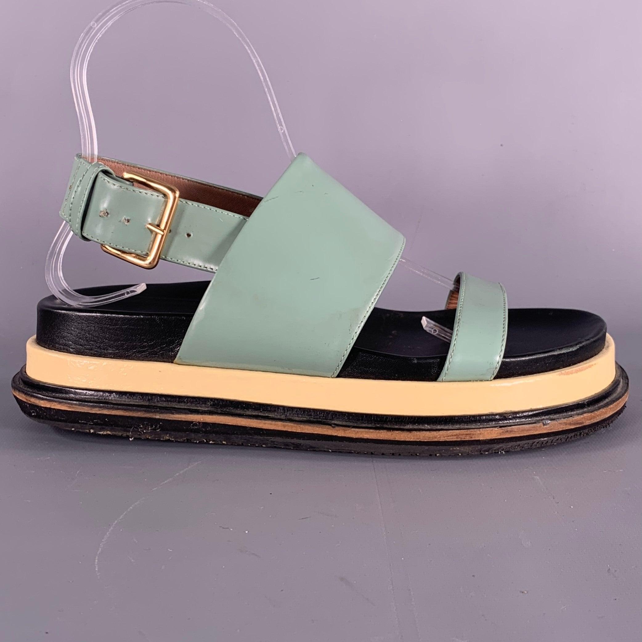 MARNI sandals
in a green fabric featuring a strappy style, chunky sole, and gold tone metal buckle closure. Made in Italy.Good Pre-Owned Condition. Moderate marks and signs of wear. Please check photos. 

Marked:   37Outsole: 10 inches  x 4.25