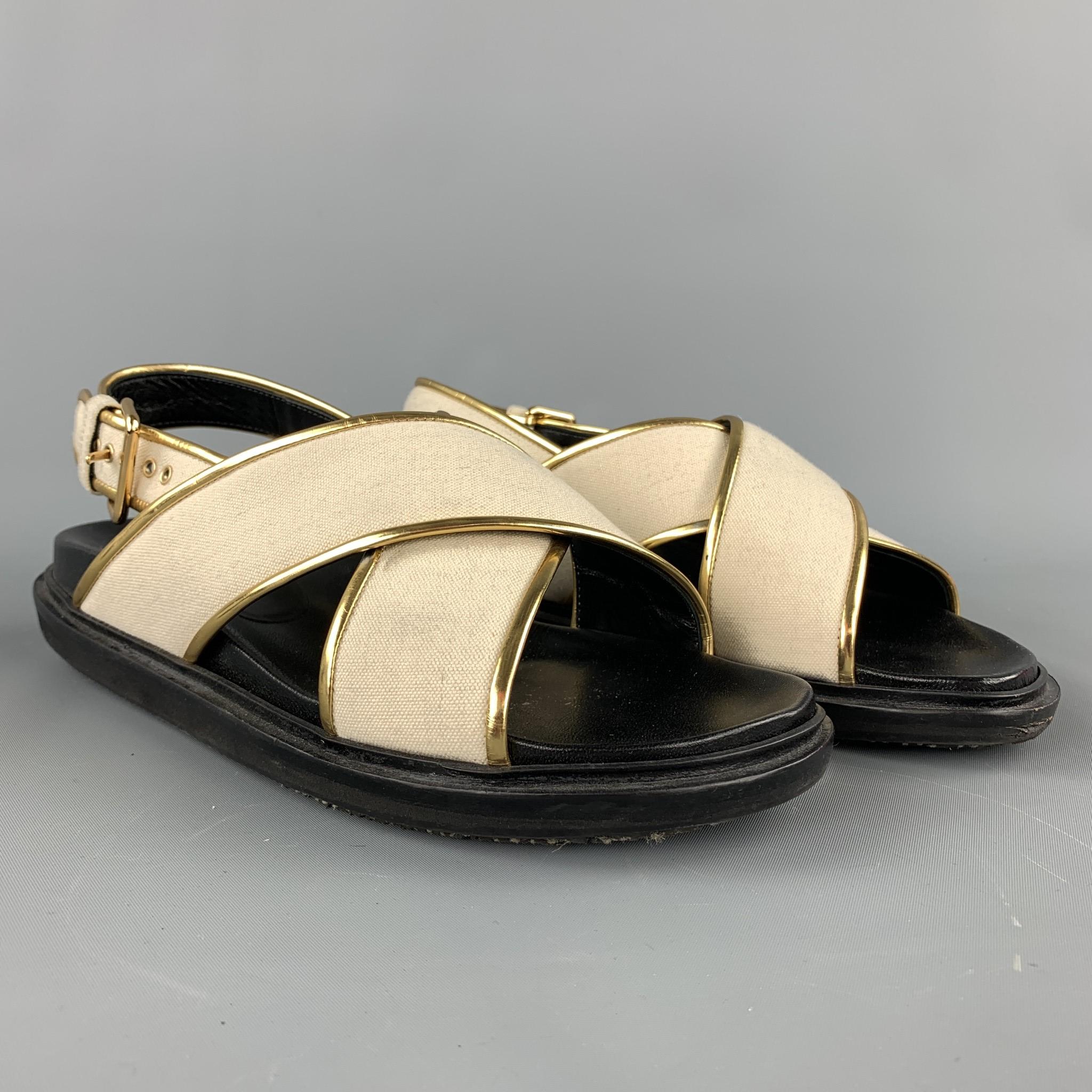 MARNI sandals comes in a black & beige canvas with a gold trim featuring a belt buckle closure. Made in Italy.

Very Good Pre-Owned Condition.
Marked: EU 38

Outsole:

10 in. x 4 in. 