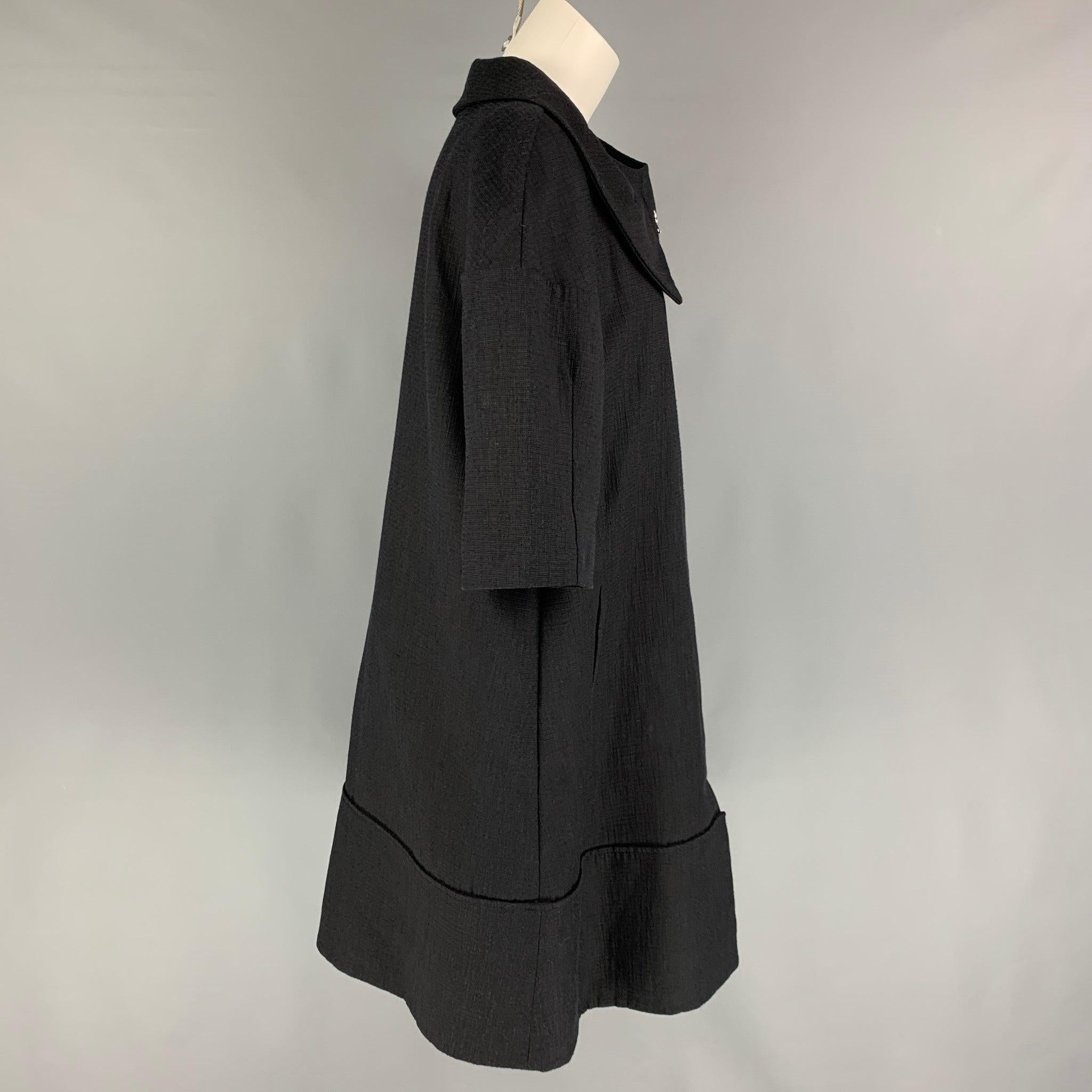 MARNI coat comes in a black textured cotton blend featuring a structured collar, slit pockets, short sleeves, and a full zip up closure. Made in Italy.
Very Good
Pre-Owned Condition. 

Marked:   44 

Measurements: 
 
Shoulder: 23 inches  Bust: 40