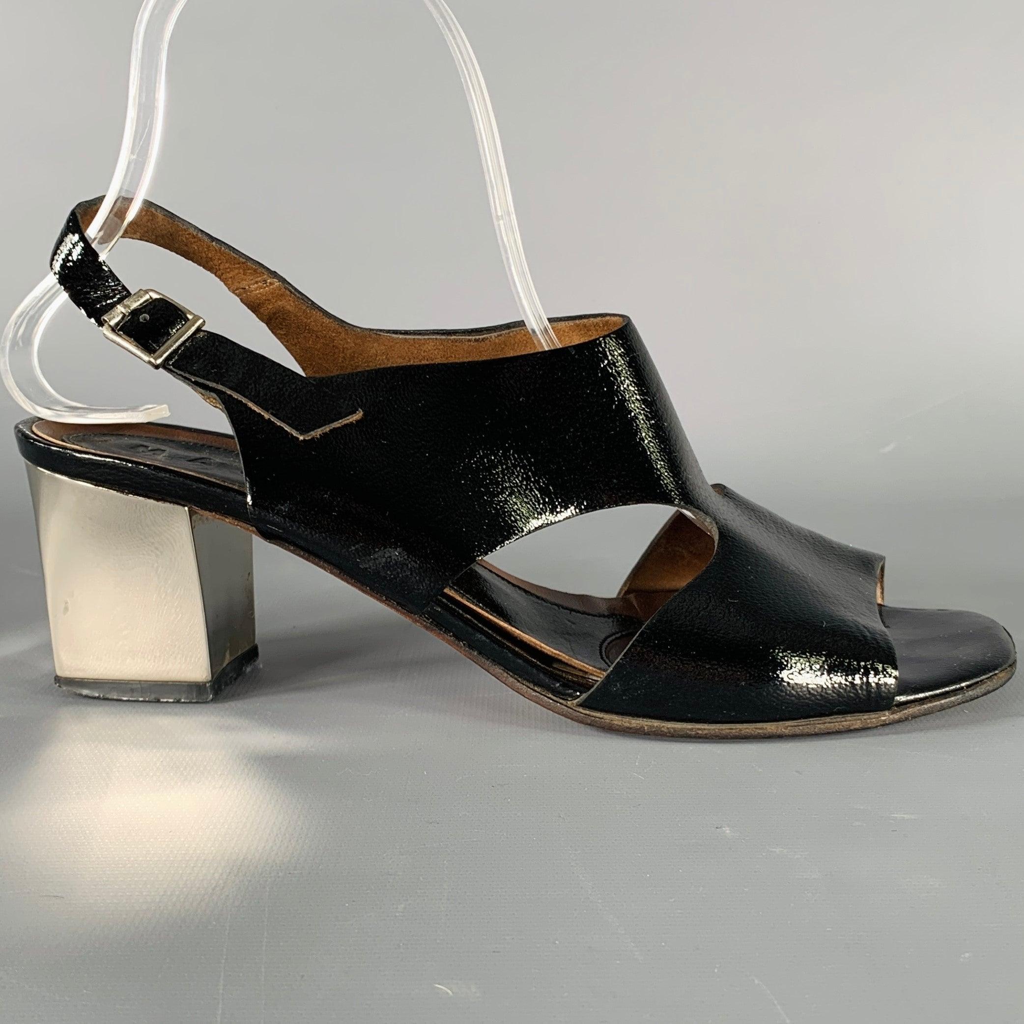 MARNI sandals
in a black patent leather featuring a slingback style, and chunky silver tone heel. Made in Italy.Very Good Pre-Owned Condition. Moderate signs of wear. 

Marked:   38 

Measurements: 
  Heel: 2.5 inches 
  
  
 
Sui Generis Reference: