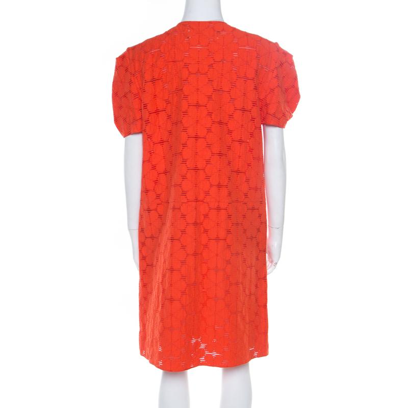 This shift dress from Marni promises to make you look ultra stylish! The tangerine creation is made of a cotton blend and features a lovely floral lace design. It flaunts puffed sleeves and comes equipped with two external pockets. Pair it with