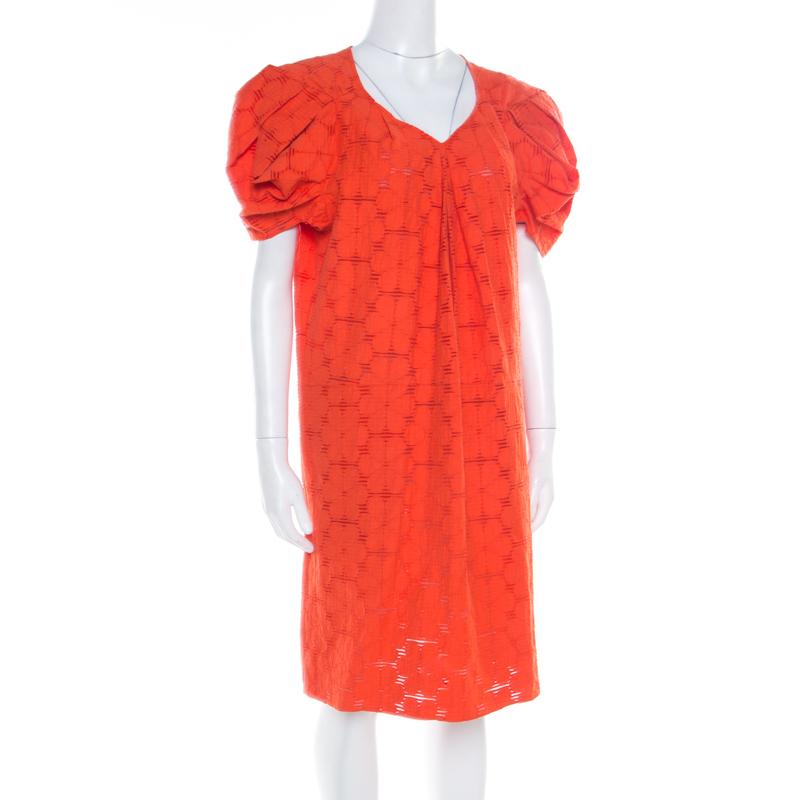 This shift dress from Marni promises to make you look ultra stylish! The tangerine creation is made of a cotton blend and features a lovely floral lace design. It flaunts puffed sleeves and comes equipped with two external pockets. Pair it with